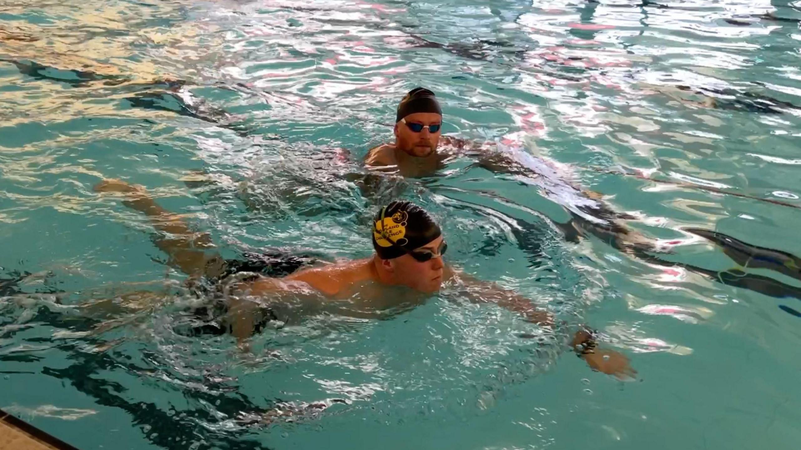 Olympic swimmer Adam Peaty OBE swimming in a pool with BBC Radio Derby's sports presenter Dominic Dietrich at Uttoxeter Leisure Centre.