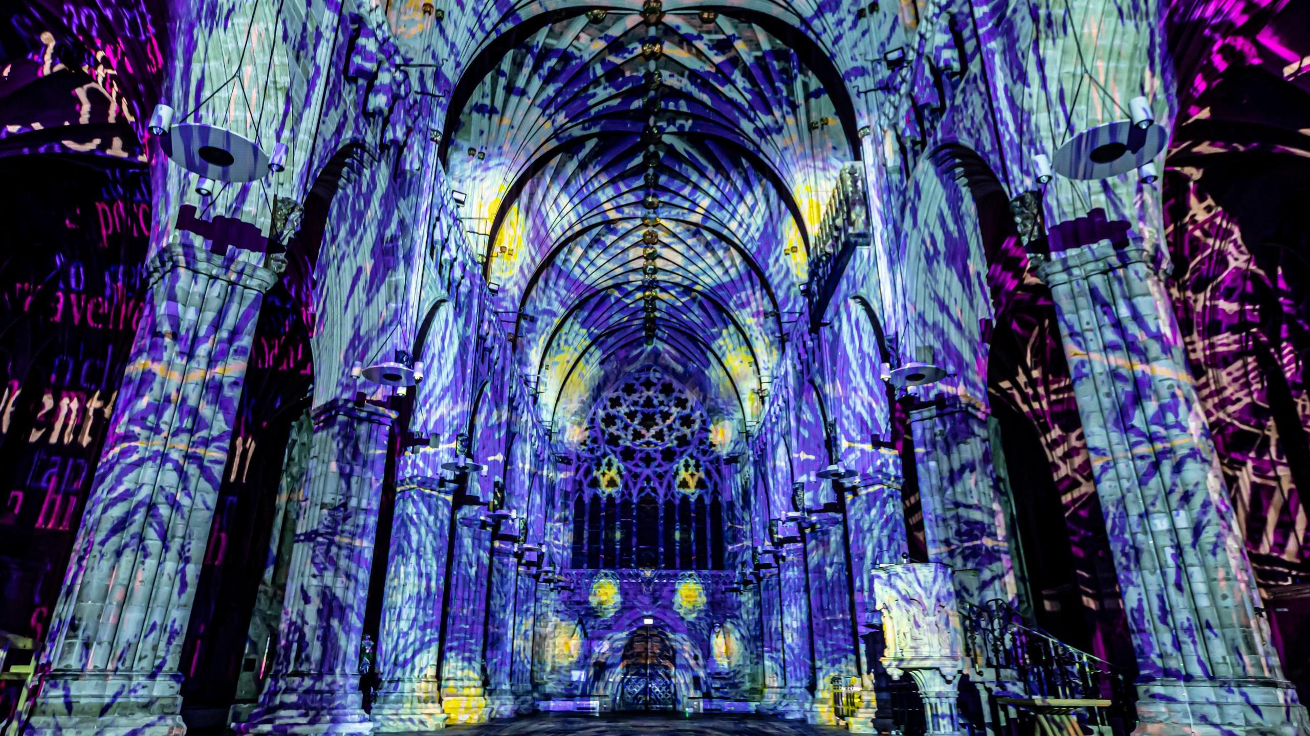 A light projection on the interior walls of a cathedral.