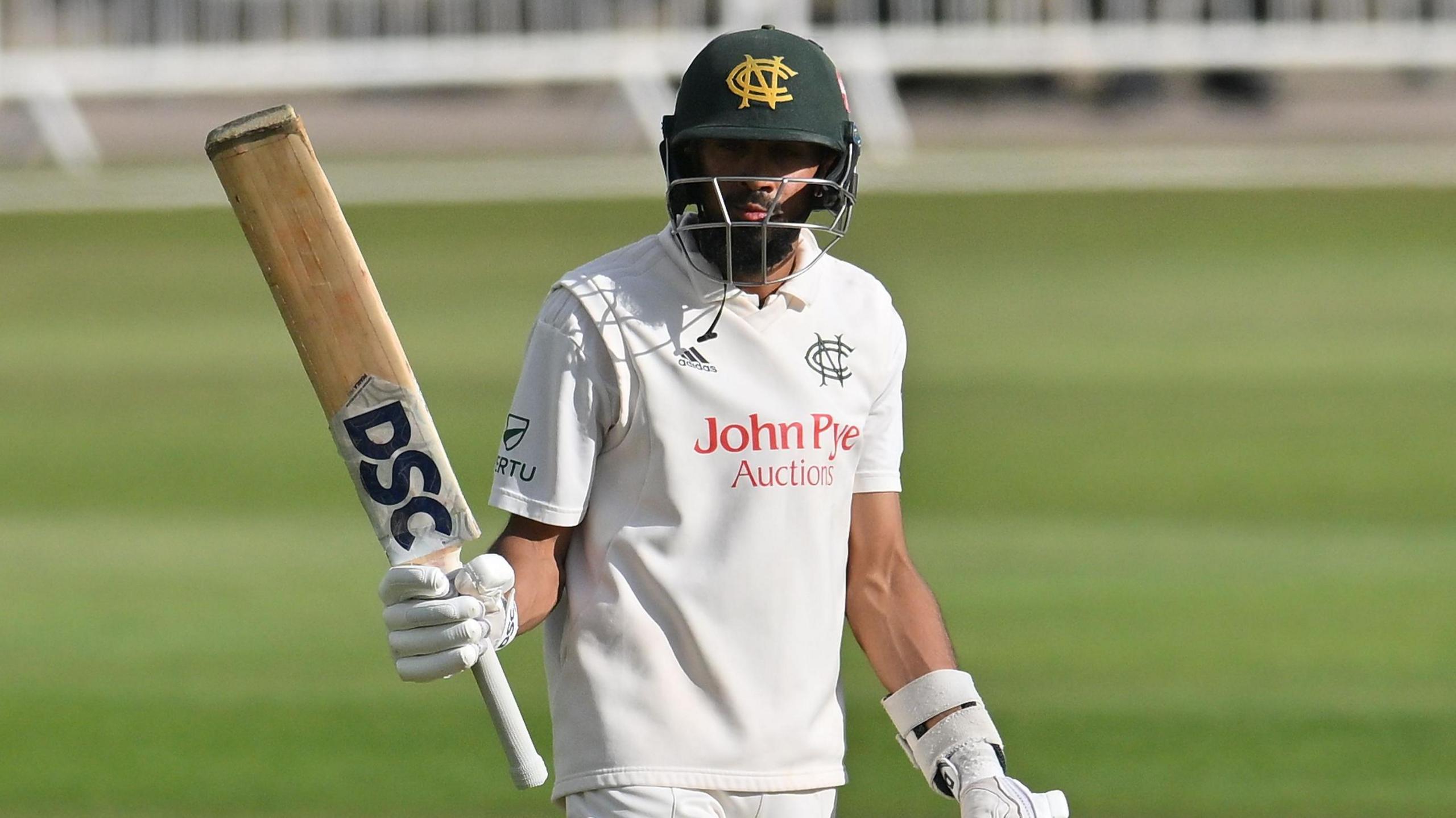 Nottinghamshire's Haseeb Hameed raising his bat after scoring a half-century.