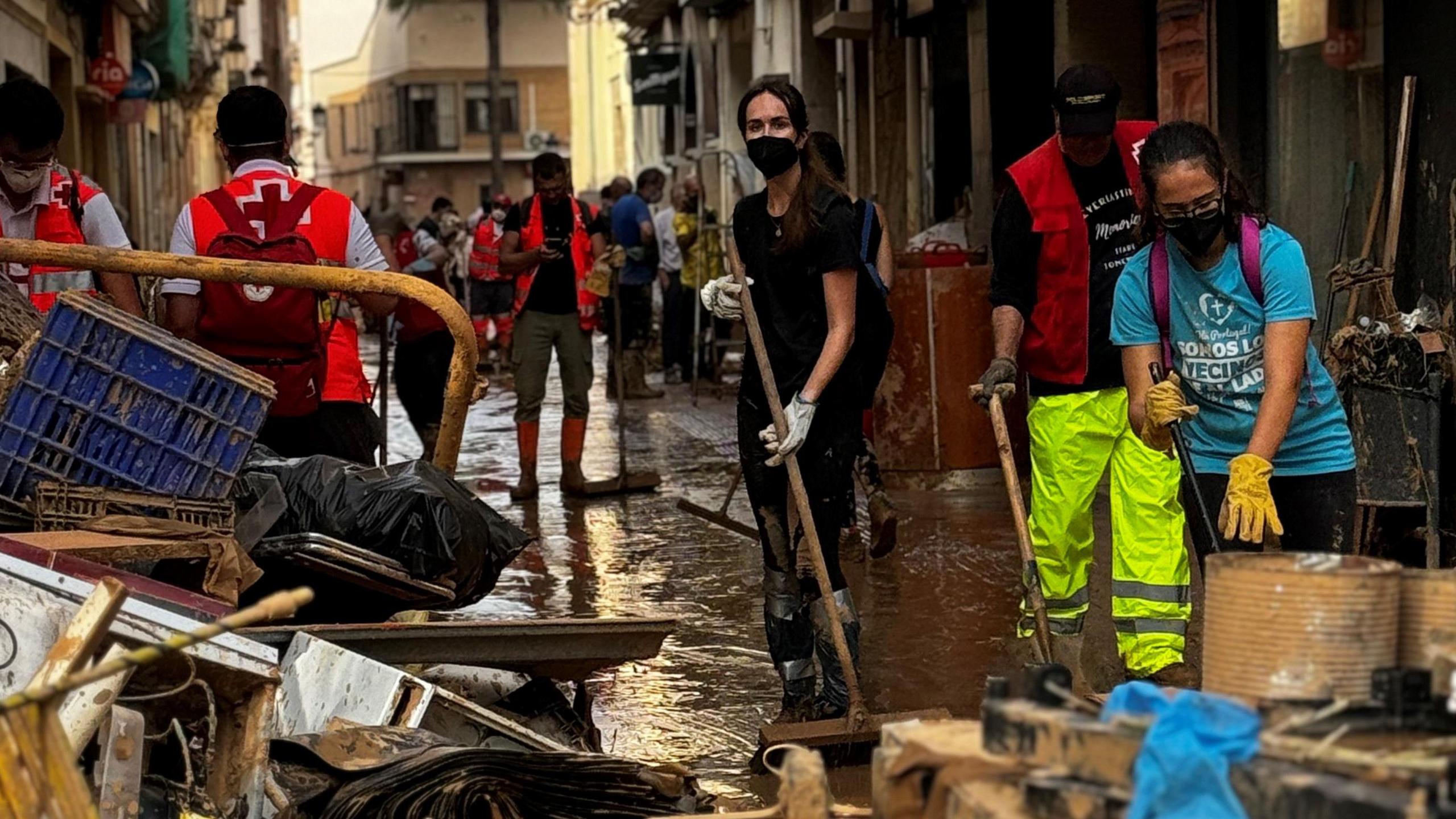 Volunteers and emergency services are working to clean the streets in Paiporta, in Spain, two weeks after the region was hit by deadly floods