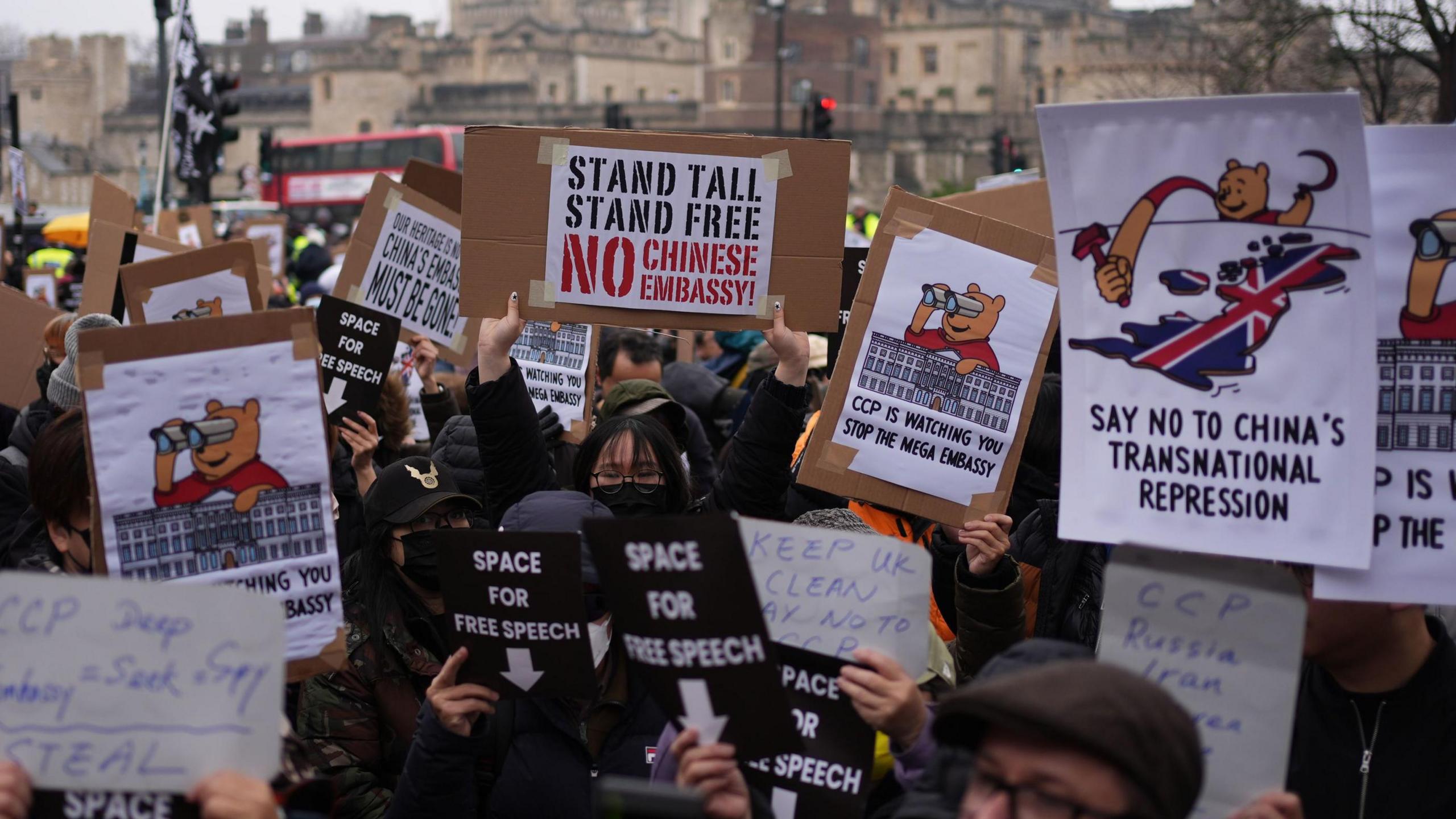 People holding up protest posters in London saying "space for free speech"