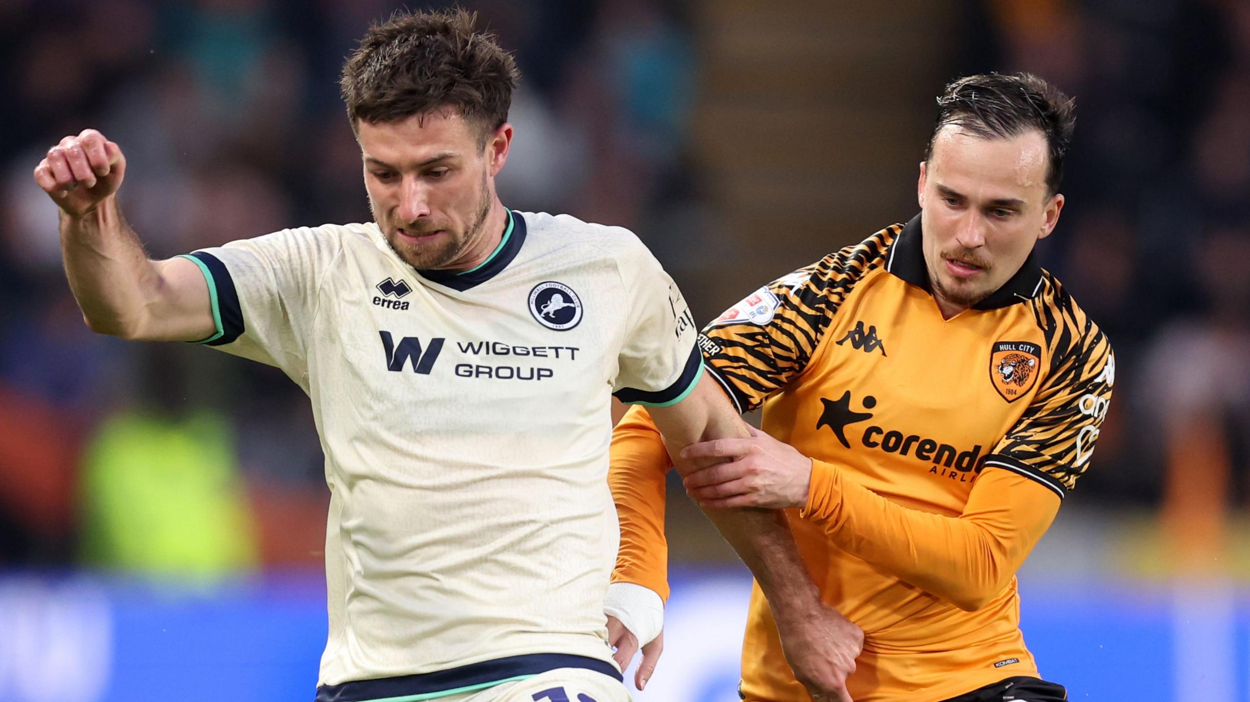Ryan Leonard (left), of Millwall, is challenged by Hull City's Liam Millar during the Championship play-Off semi-final first Leg at MKM Stadium