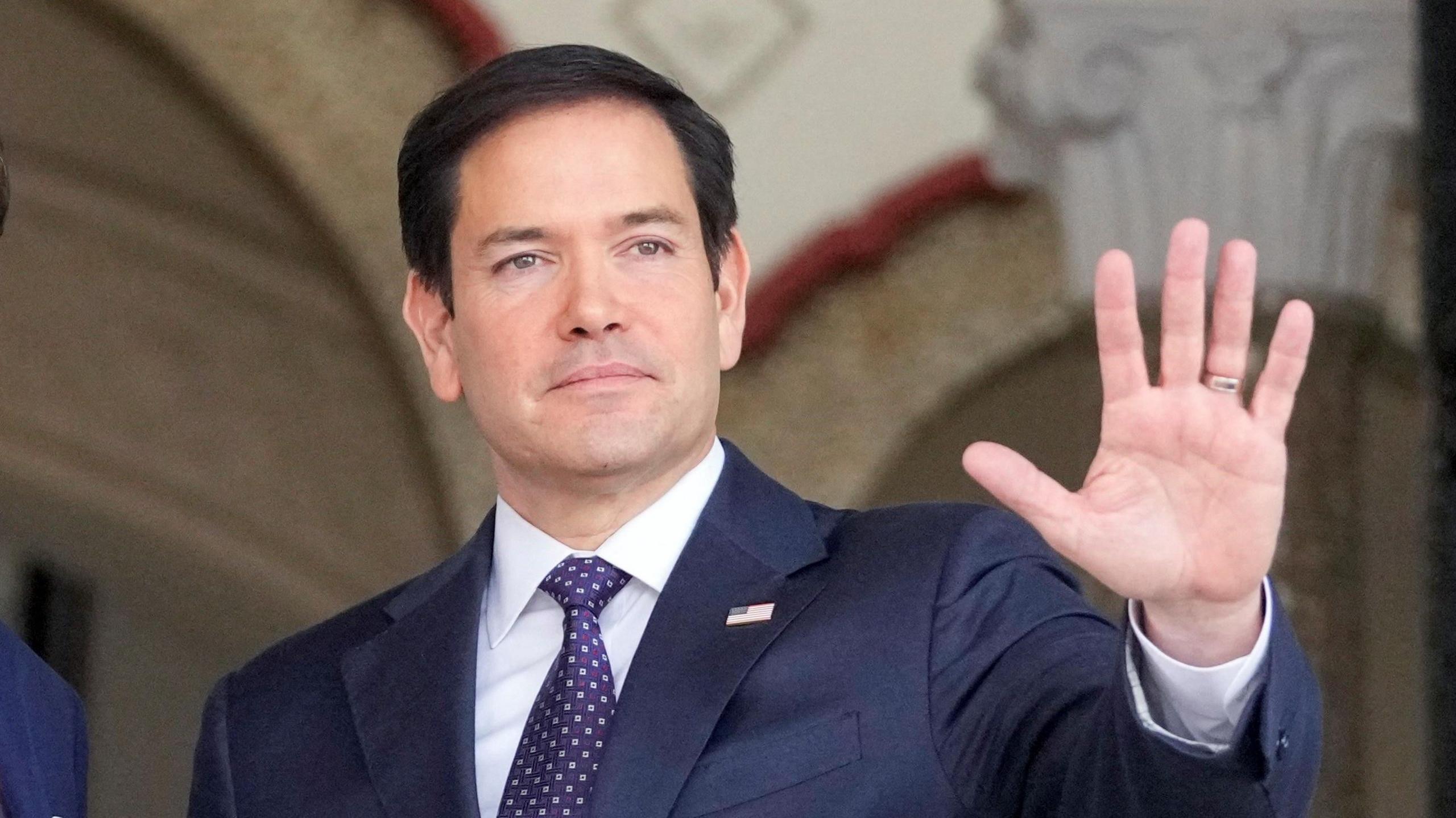 US Secretary of State Marco Rubio waves after arriving at the presidential palace in Panama City