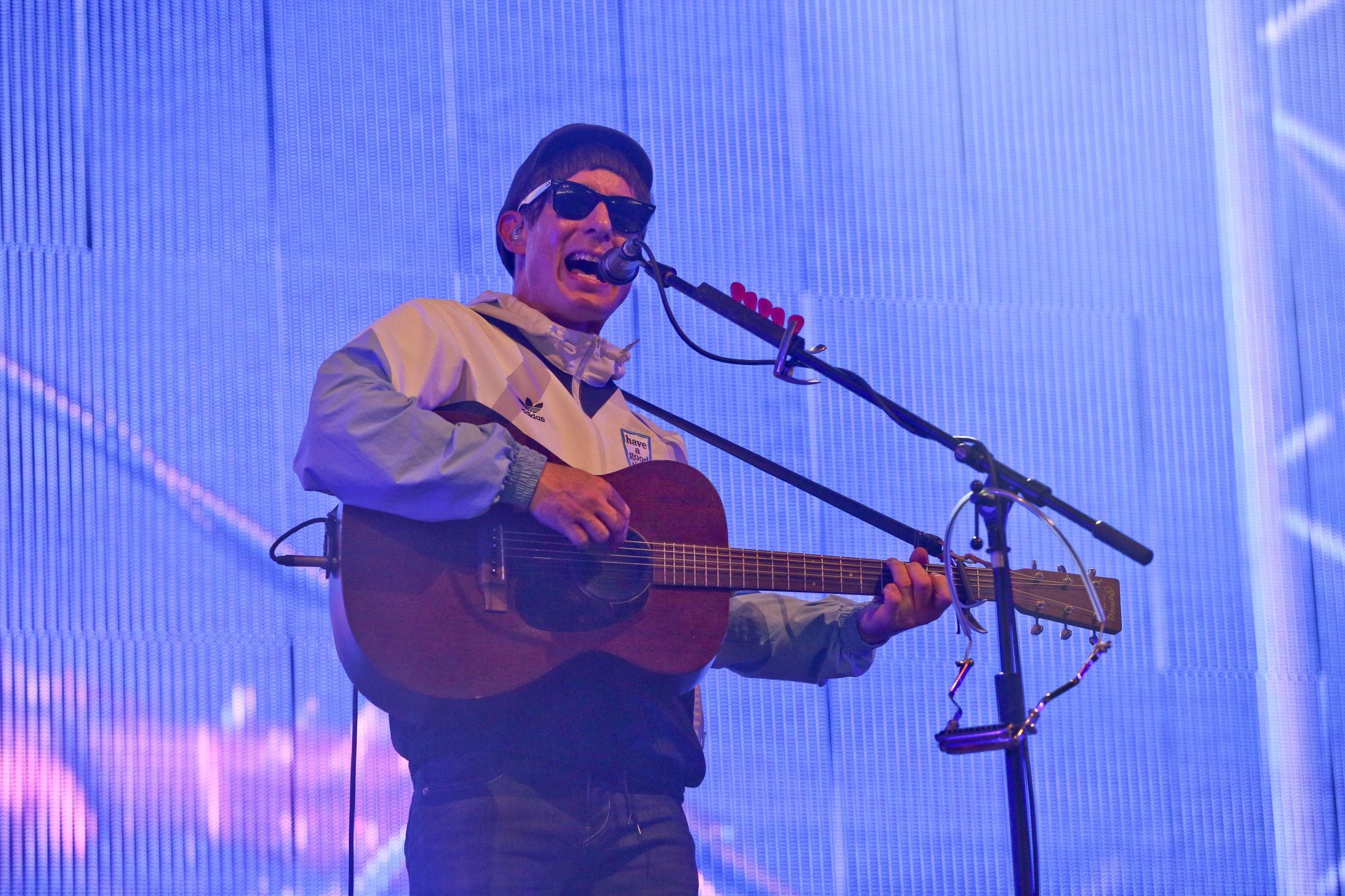 Gerry Cinnamon strumming guitar and performing live