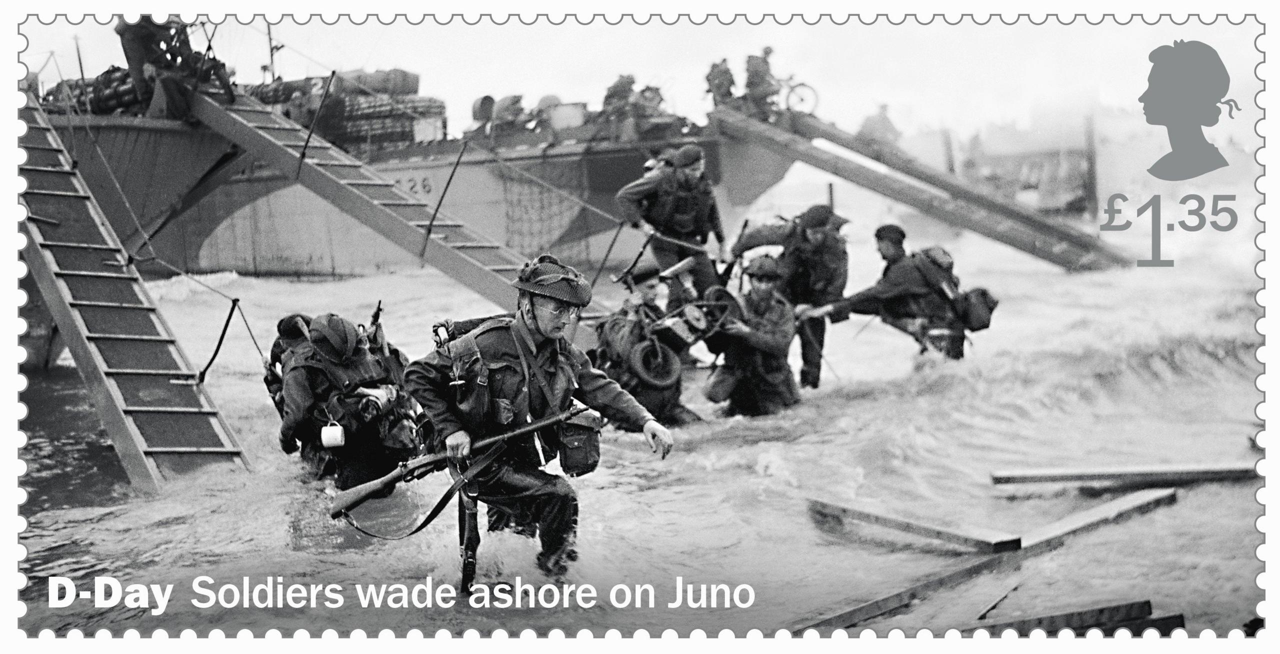 Soldiers wade ashore on Juno beach.