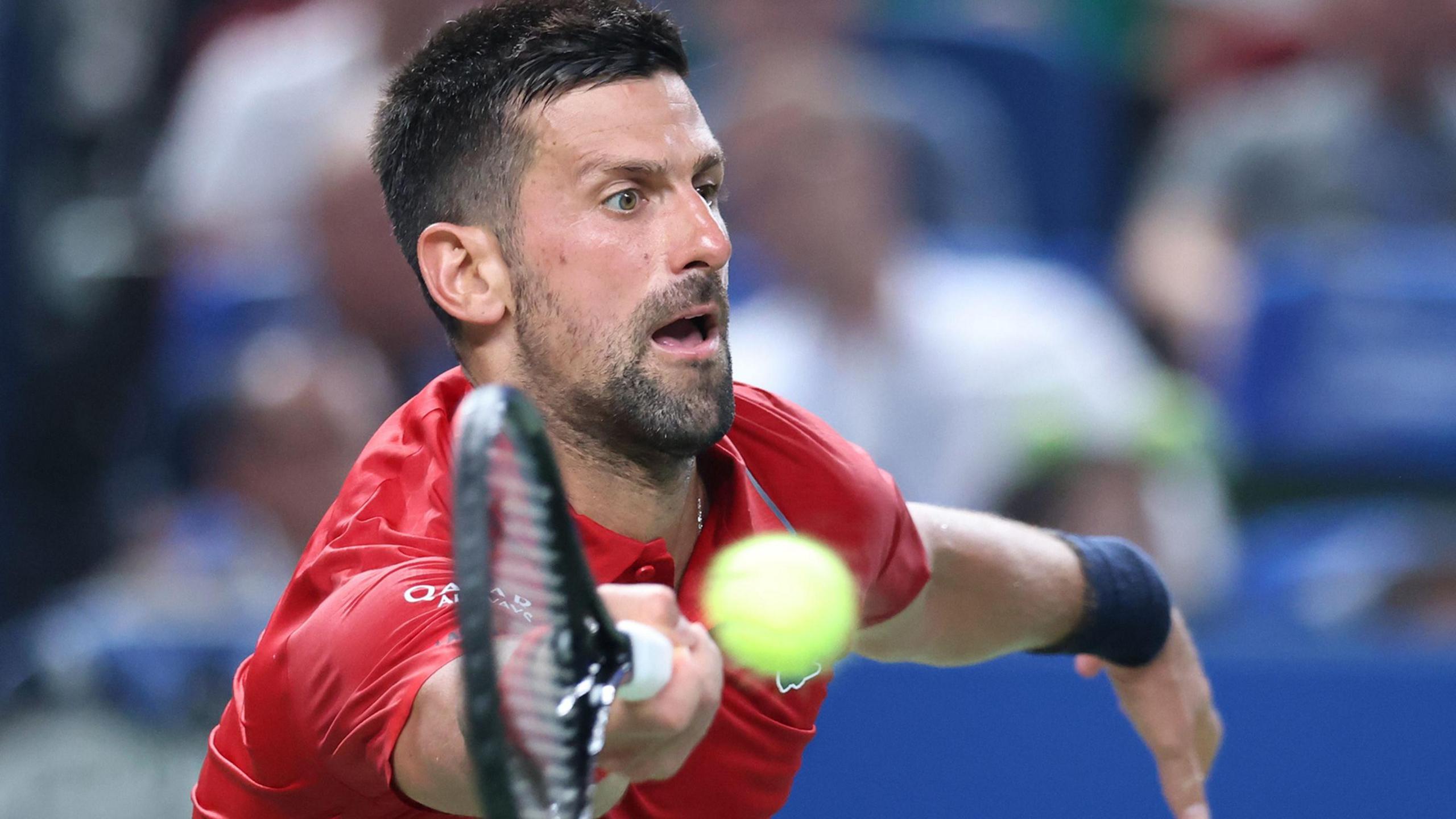 Novak Djokovic plays a forehand against Marin Cilic at the Shanghai Masters