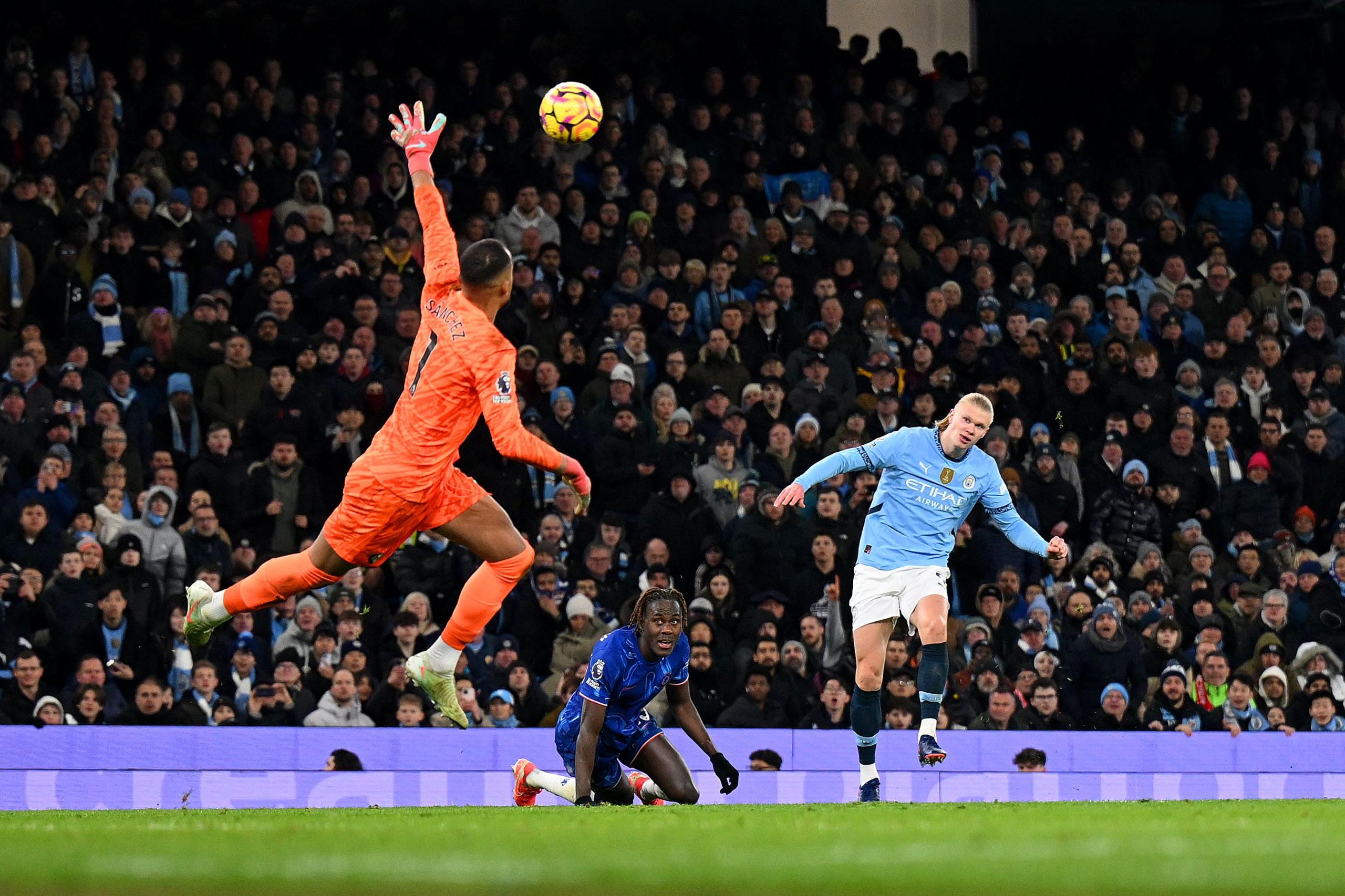 Erling Haaland of Manchester City scores his team's second goal past Robert Sanchez of Chelsea during the Premier League match between Manchester City and Chelsea at Etihad Stadium