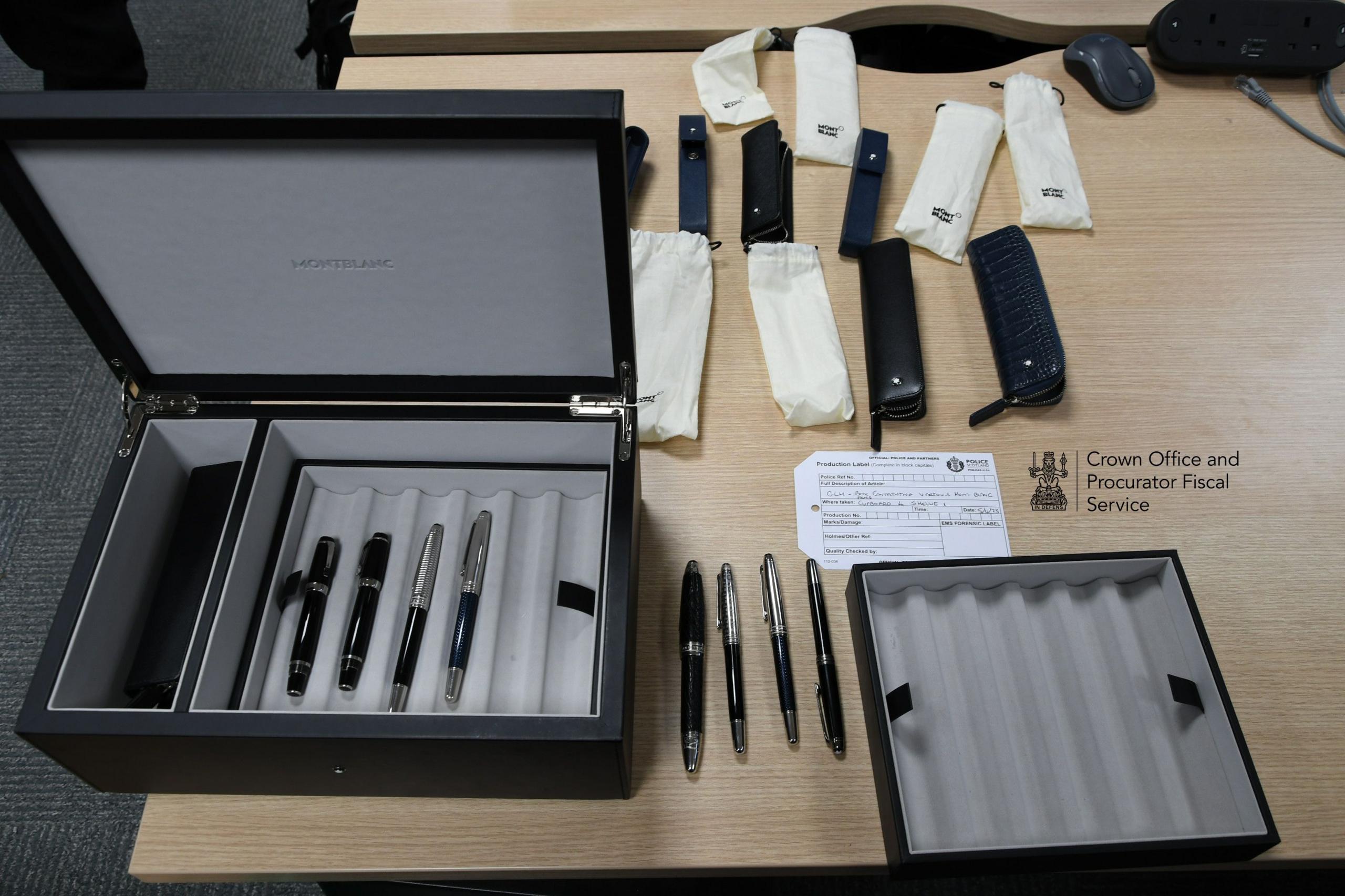 Crown Office photograph of pens on a wooden desk