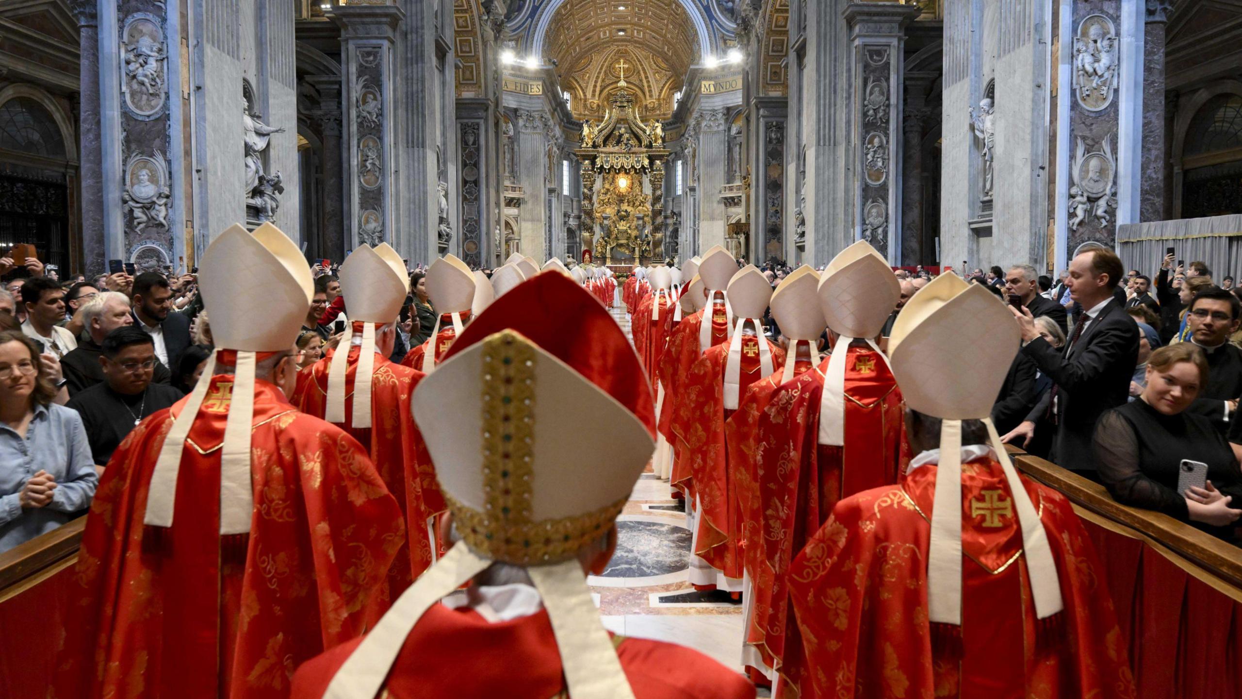 Cardinals attending a special mass at St Peter's Basilica in Rome. Members of the public are also in attendance.