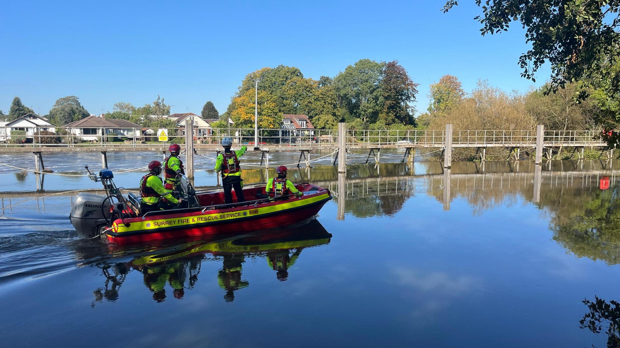 A team of rescuers on an inflatable boat sailing across a lake