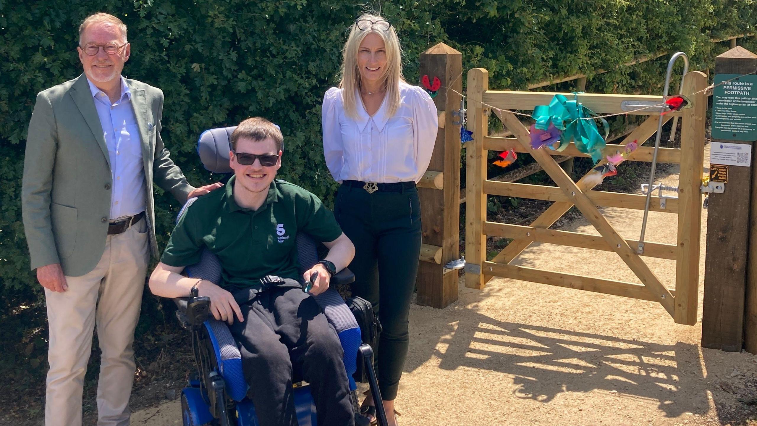 Councillor Paul Hodgkinson, National Star student Callum and Lynette Barrett, National Star Chief Executive, at the opening of the new accessible path at National Star College in Ullenwood
