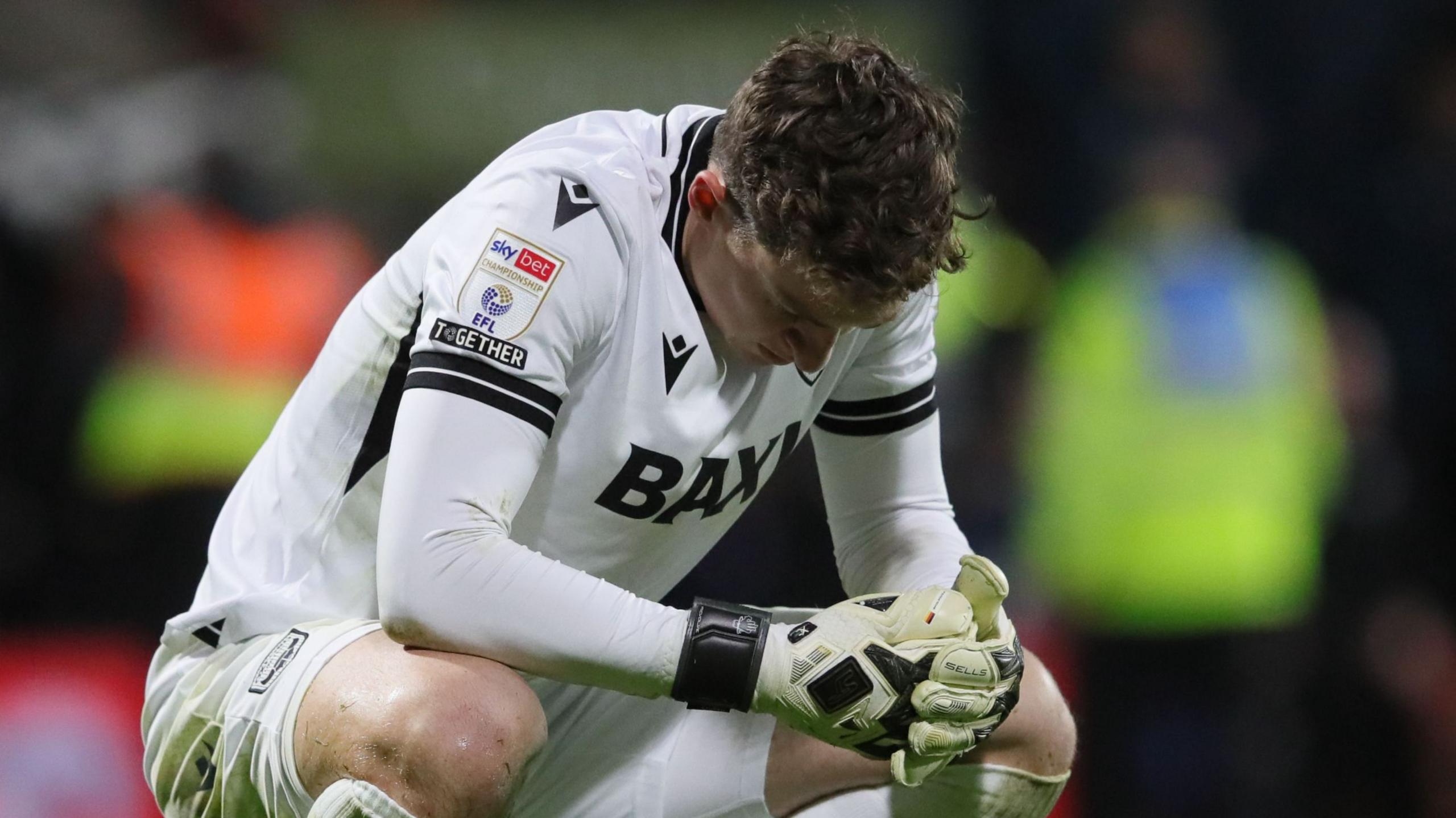 Oxford United goalkeeper Jamie Cumming looks dejected