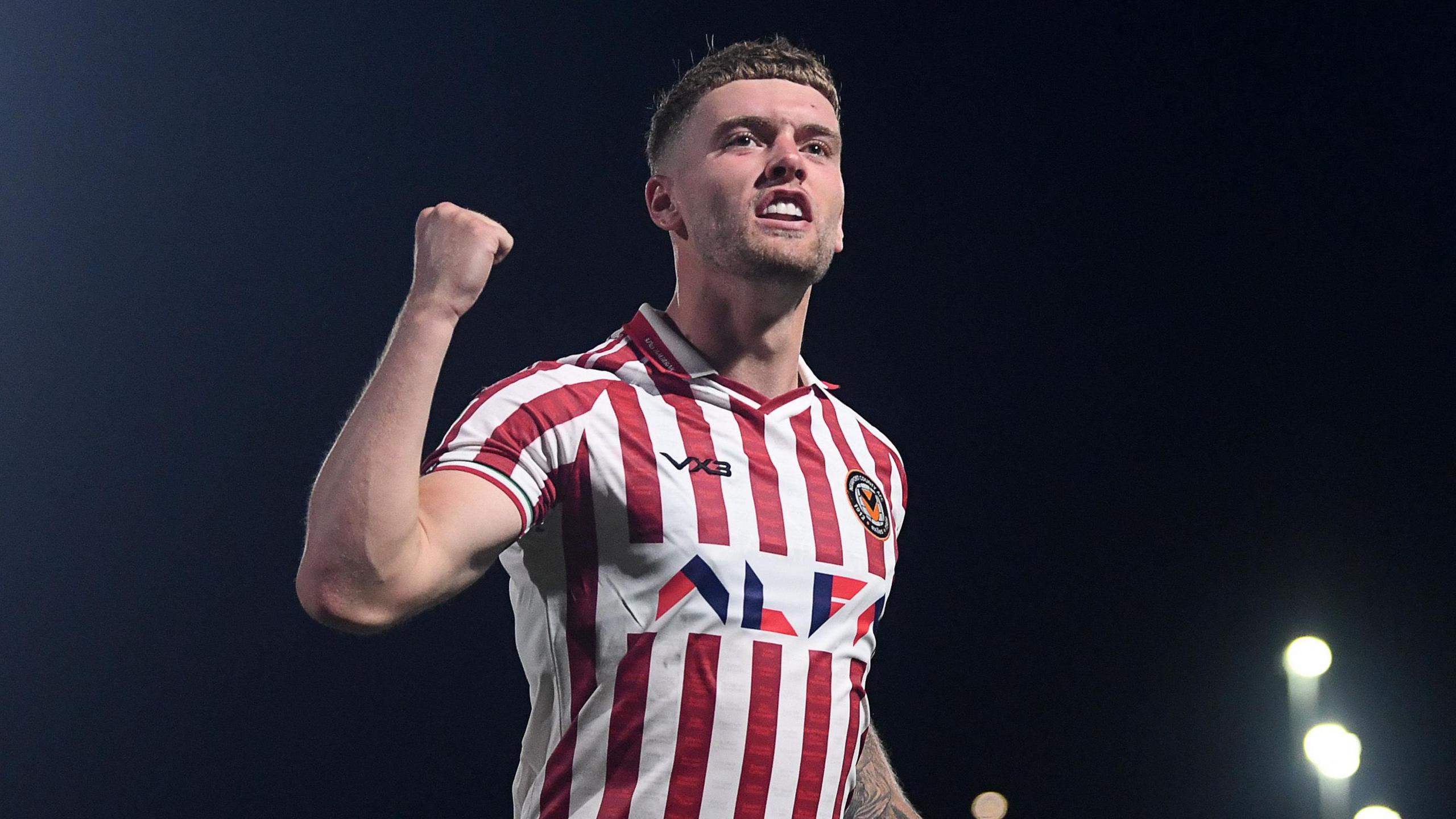 Cameron Evans celebrates after scoring for Newport