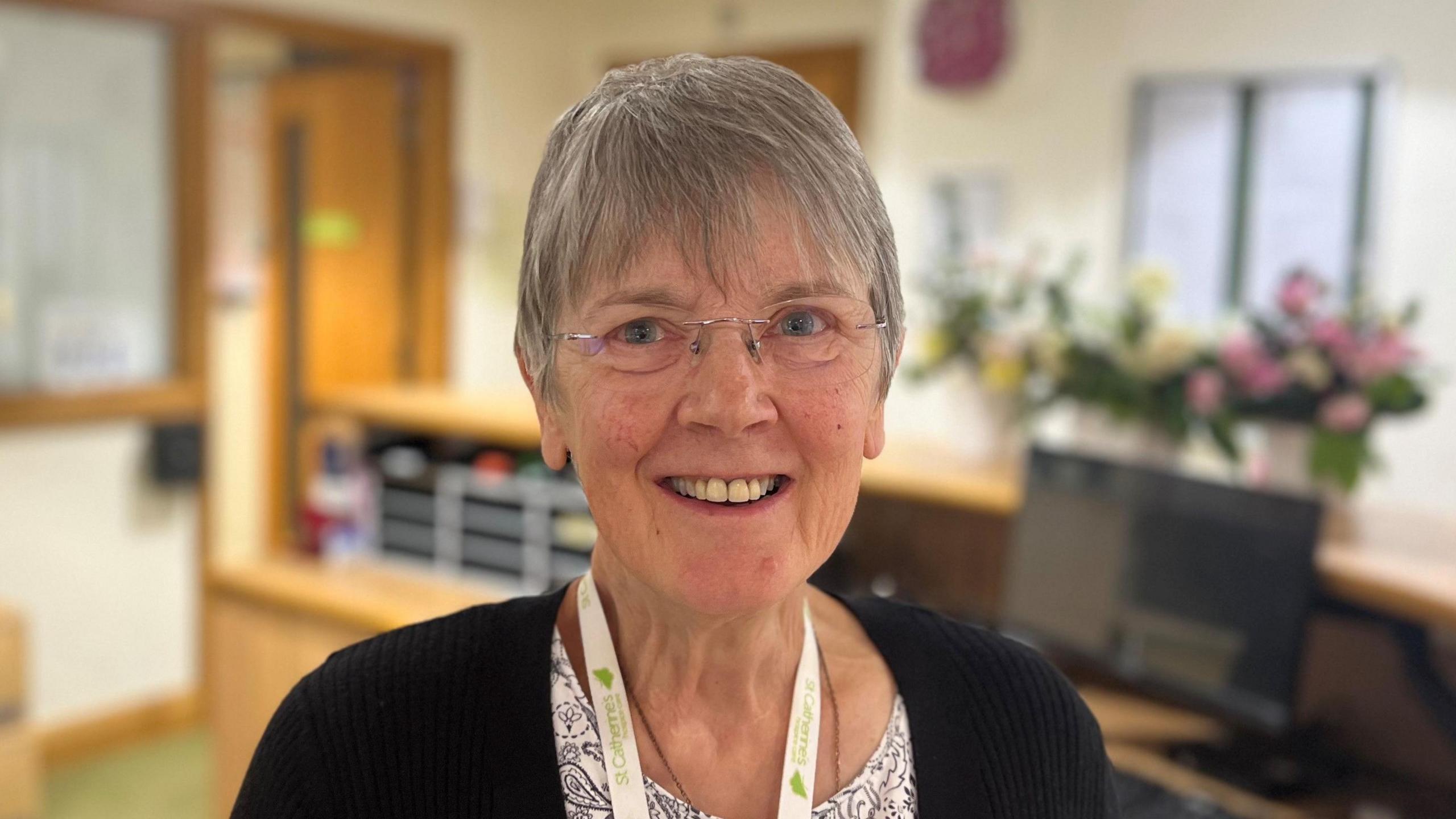 Wendy Barber smiling in the reception of St Catherine's Hospice