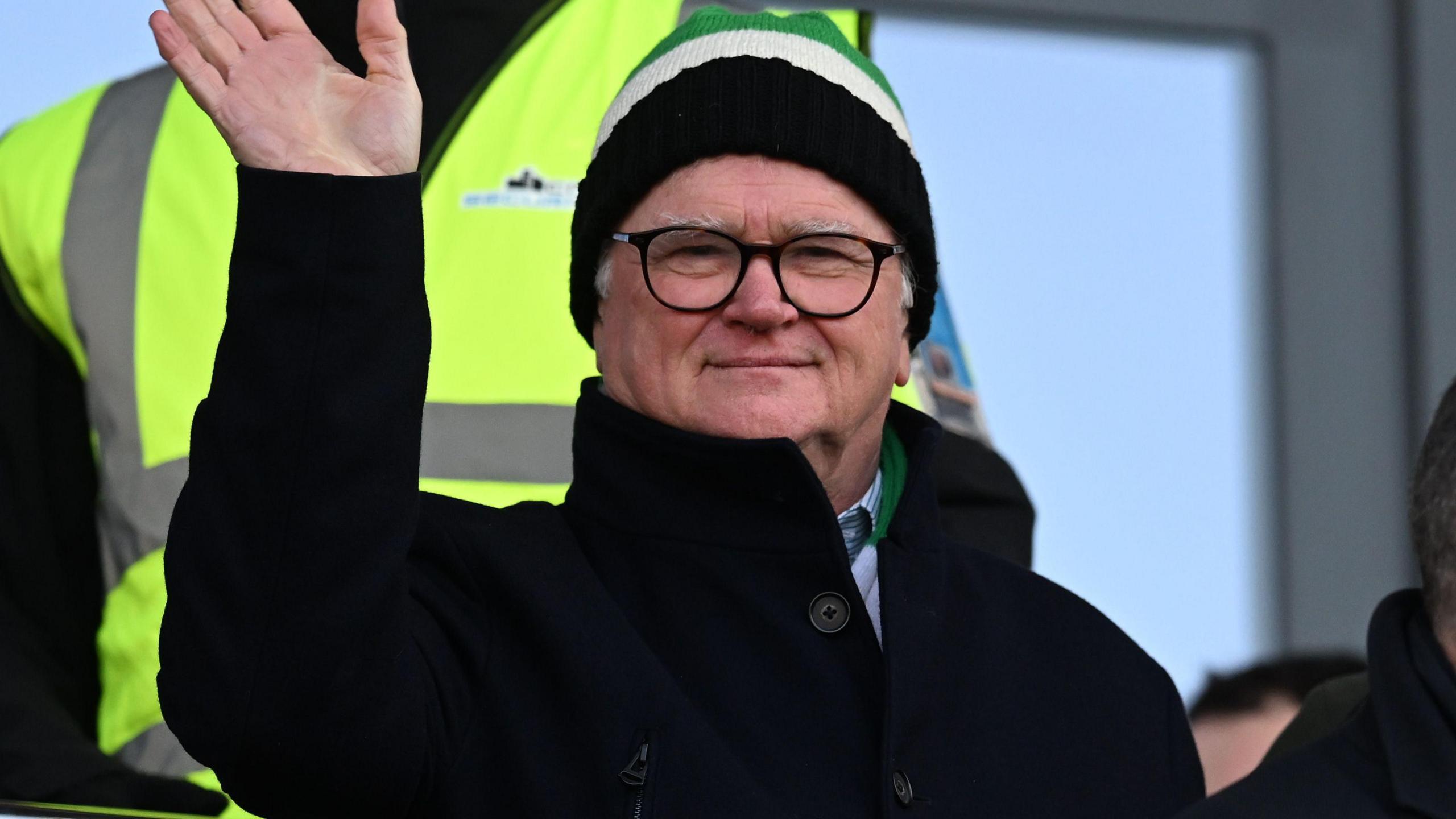Simon Hallett waves while watching Plymouth play