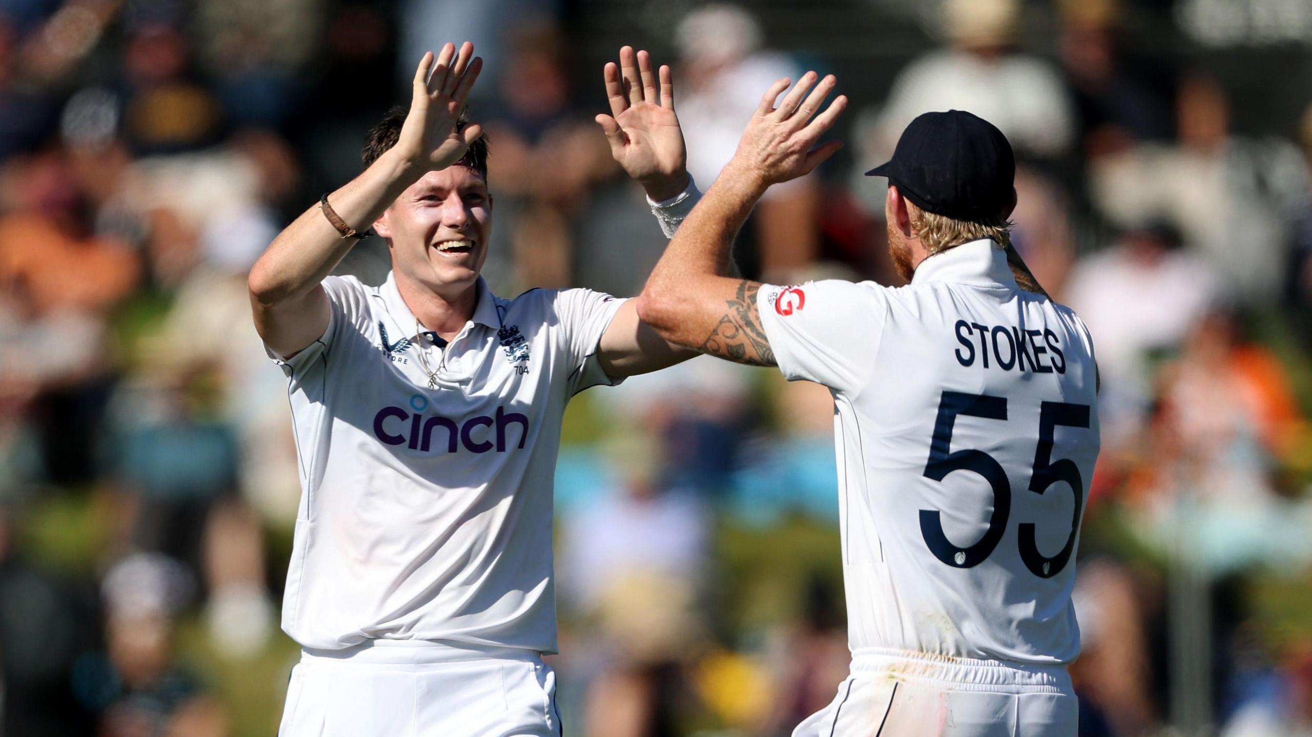 England bowler Matthew Potts (left) celebrates taking a wicket with skipper  Ben Stokes (right)