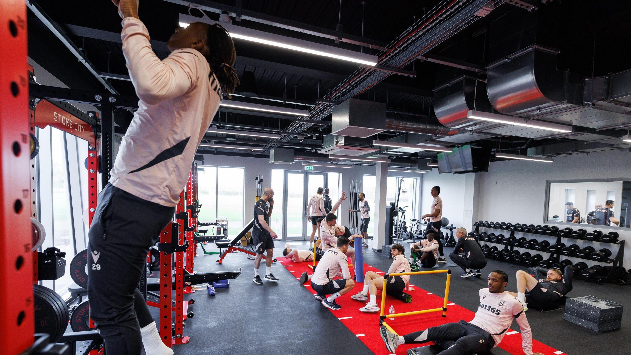 A view inside Stoke City's new training facility showing players working in a weights room