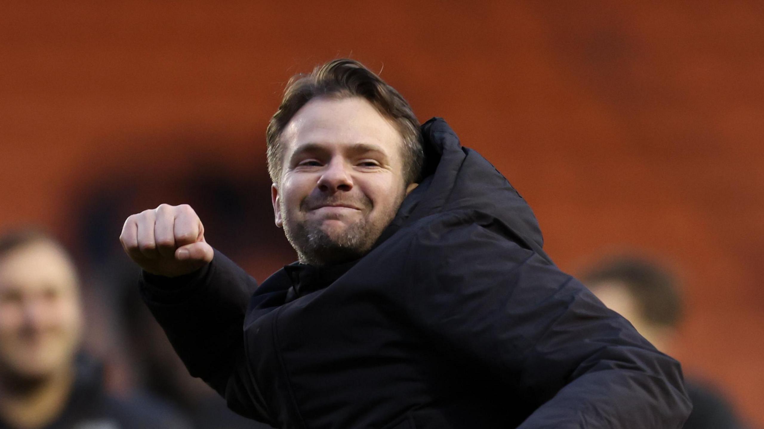 Plymouth Argyle boss Tom Cleverley punching the air in celebration.