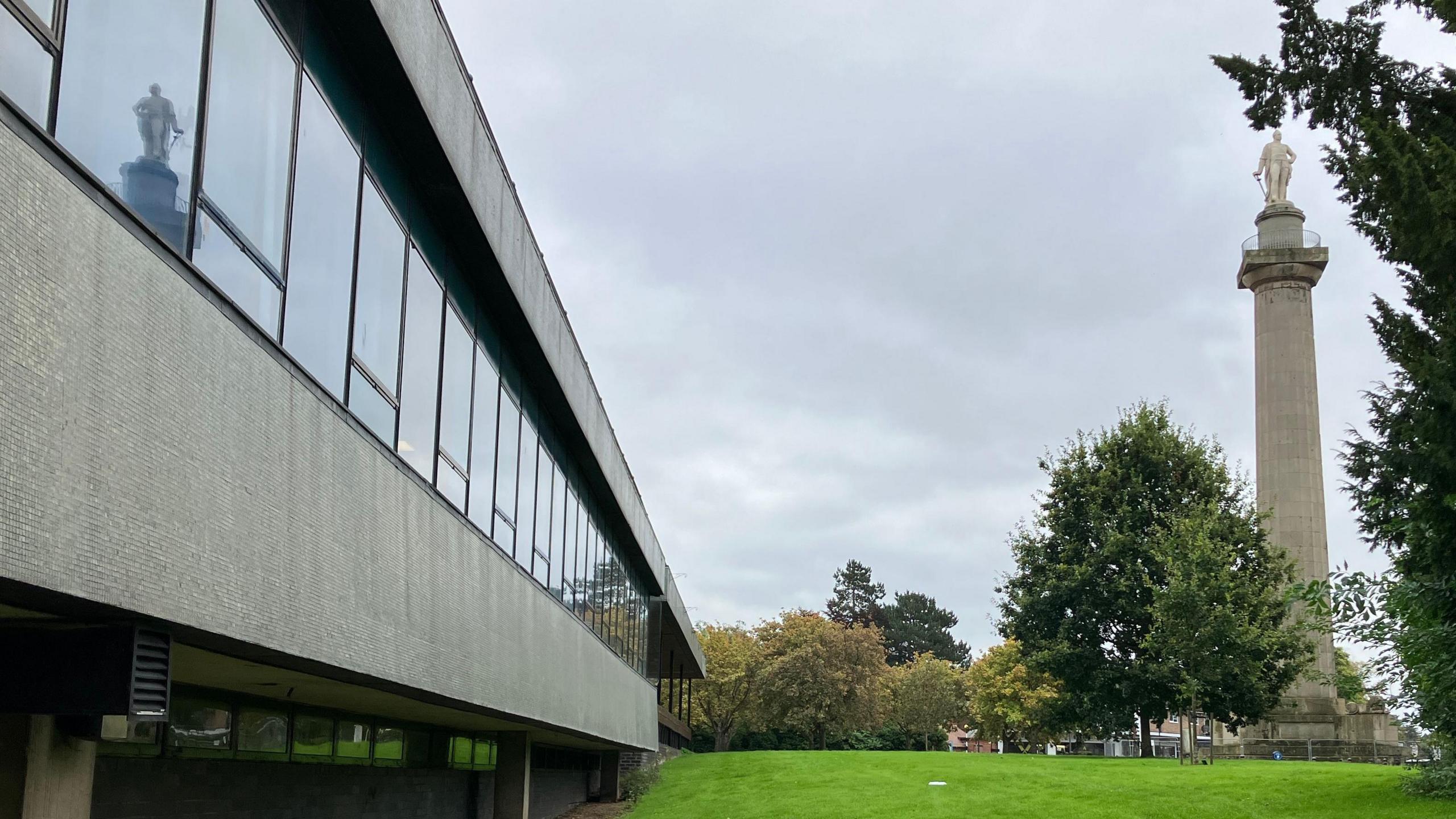 Shropshire Council's headquarters, Shirehall, on the left hand side, and Lord Hill's statue on top of a tall coade stone column on the right hand side