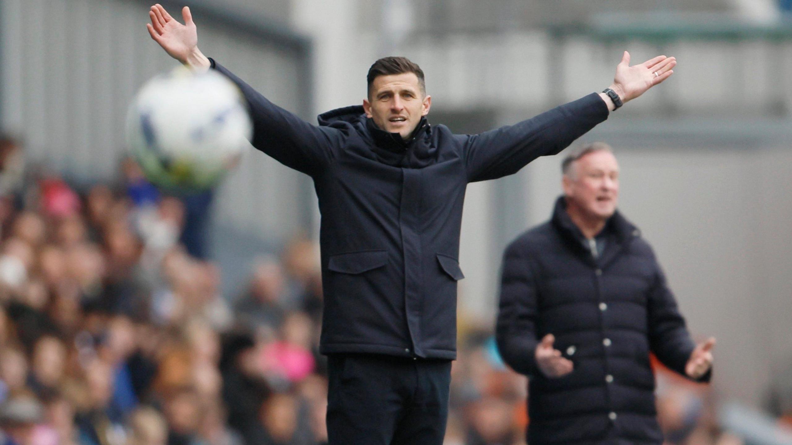 John Mousinho has his arms in the air at Ewood Park