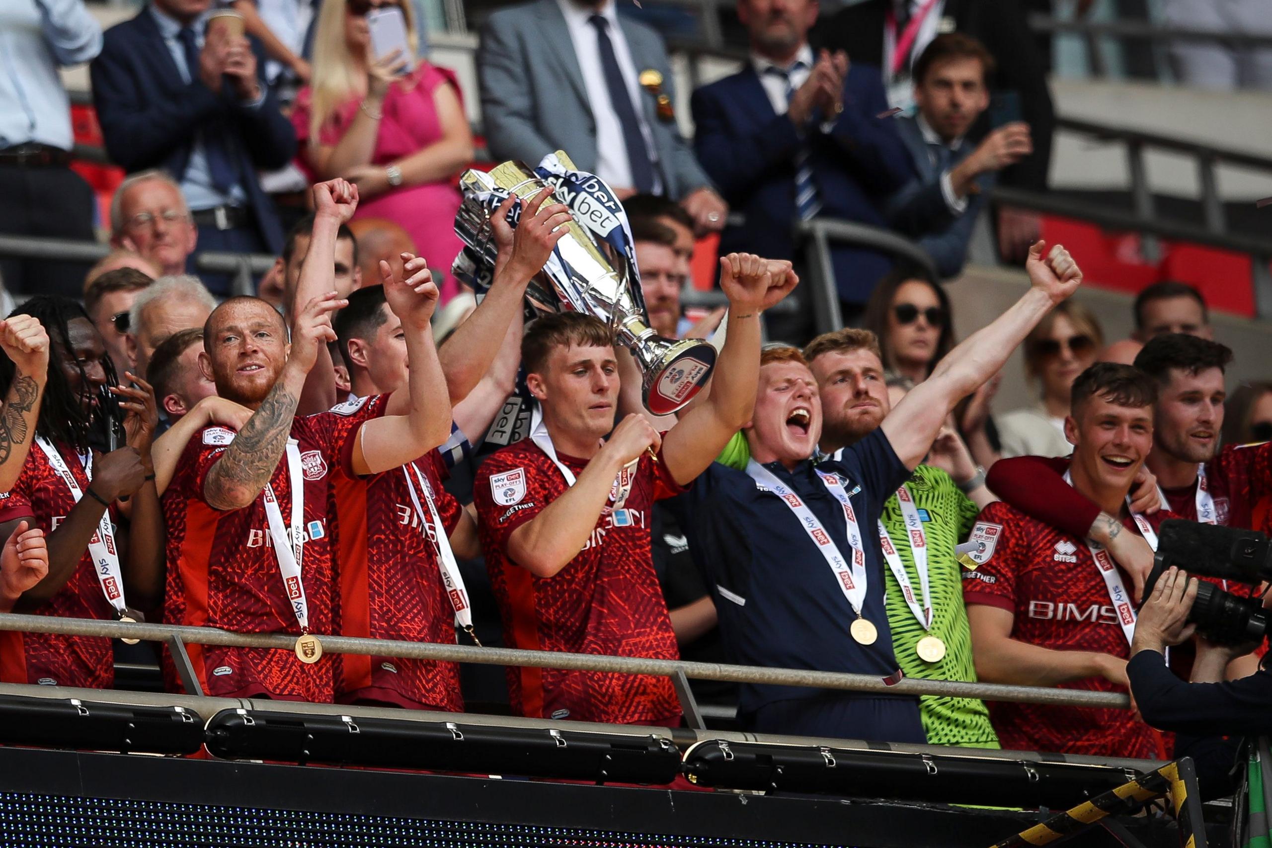 Carlisle lifting the League Two play-off final trophy at Wembley in May 2023 
