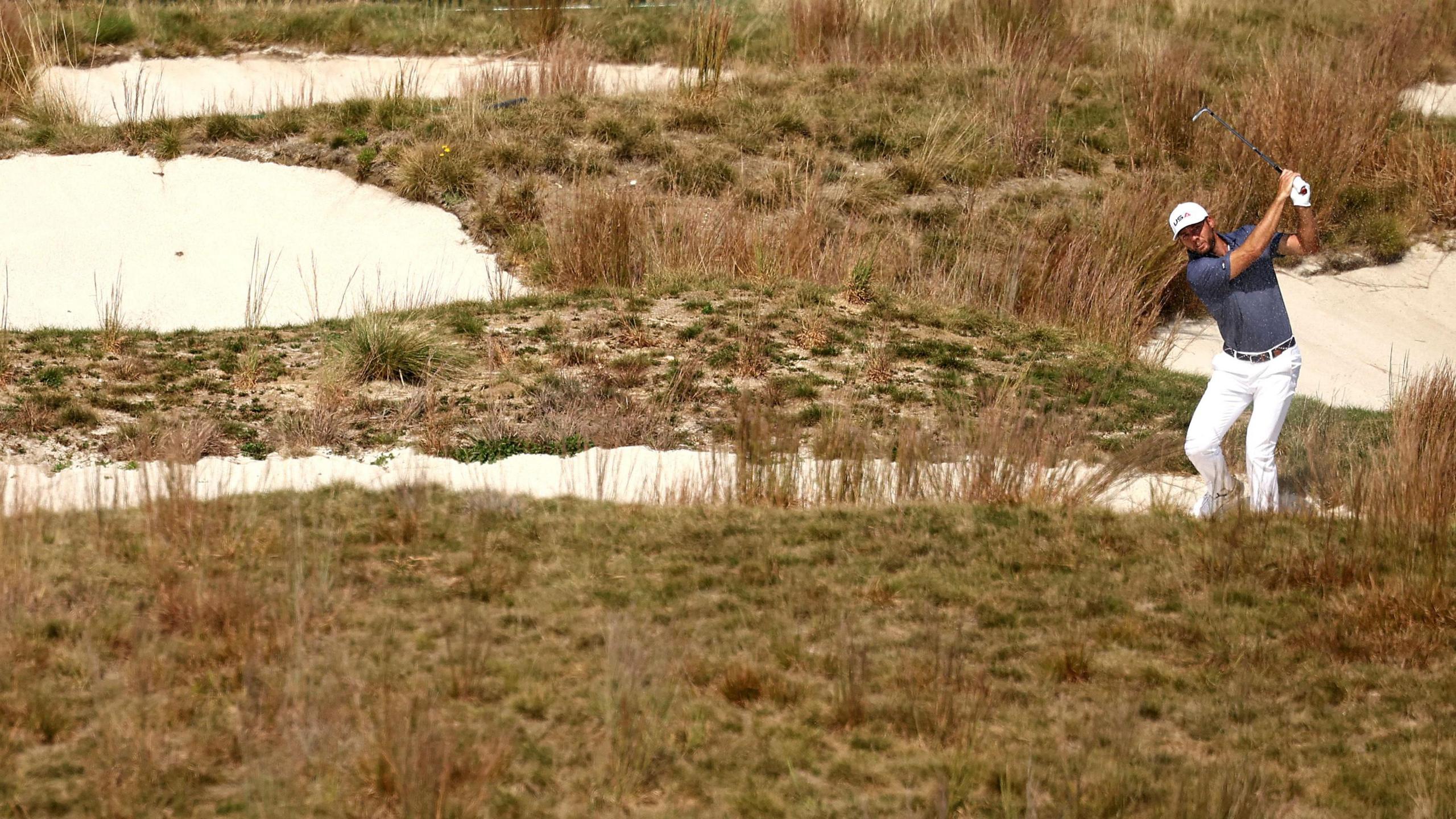 US Ryder Cup player Sam Burns hits a shot out of the rough in a practice round on Tuesday