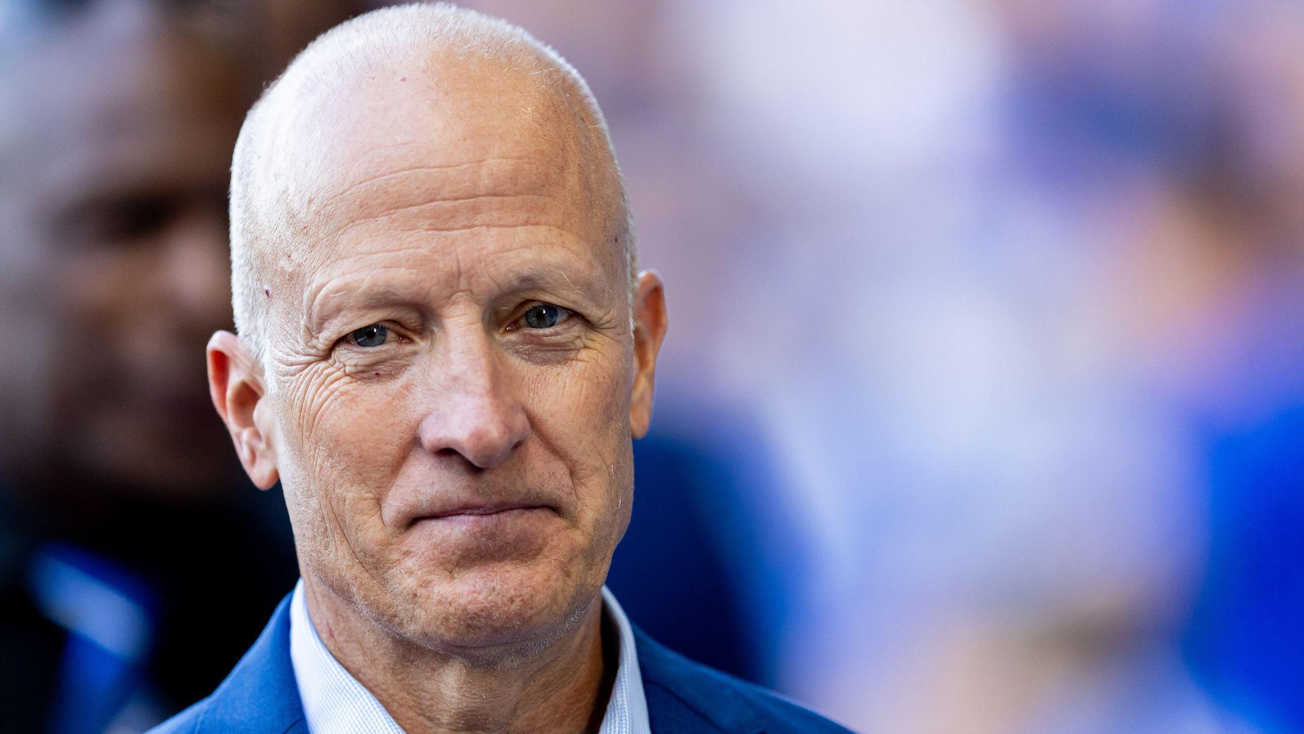 Tom Wagner, owner of Birmingham City Football Club, is pictured in a suit, looking directly at the camera.