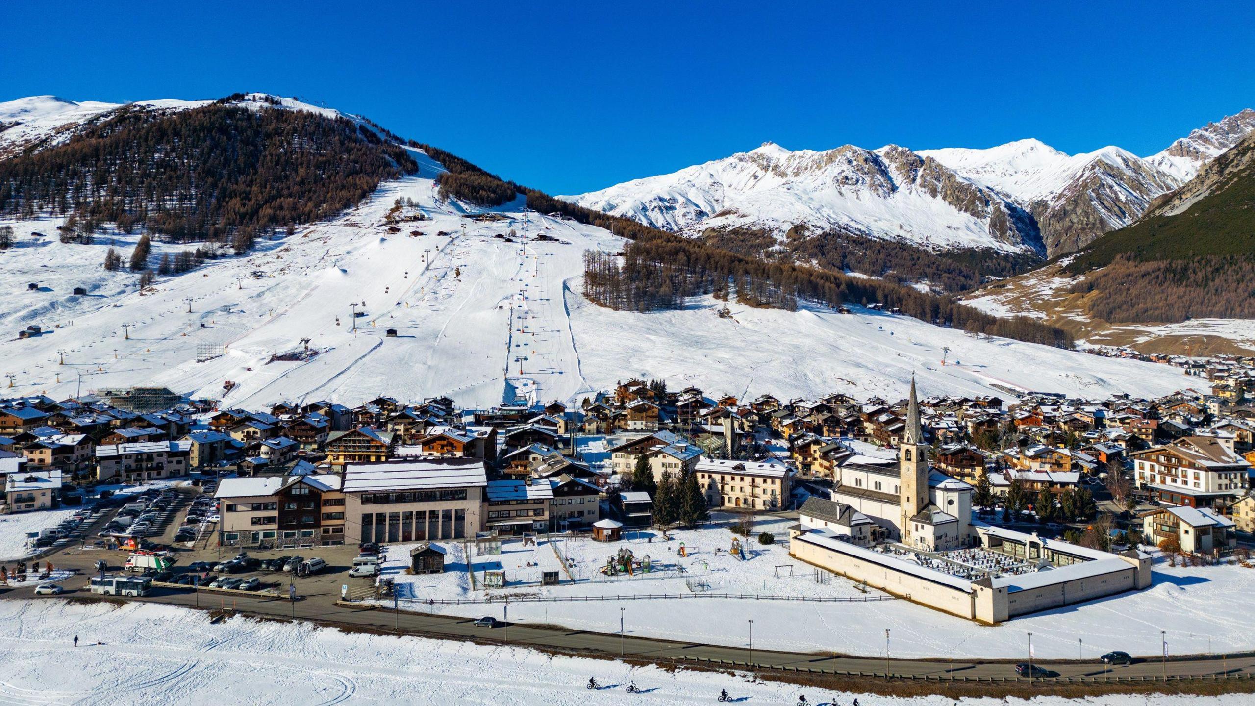 Drone photo of Livigno, a small town at the bottom of a snow-covered mountain