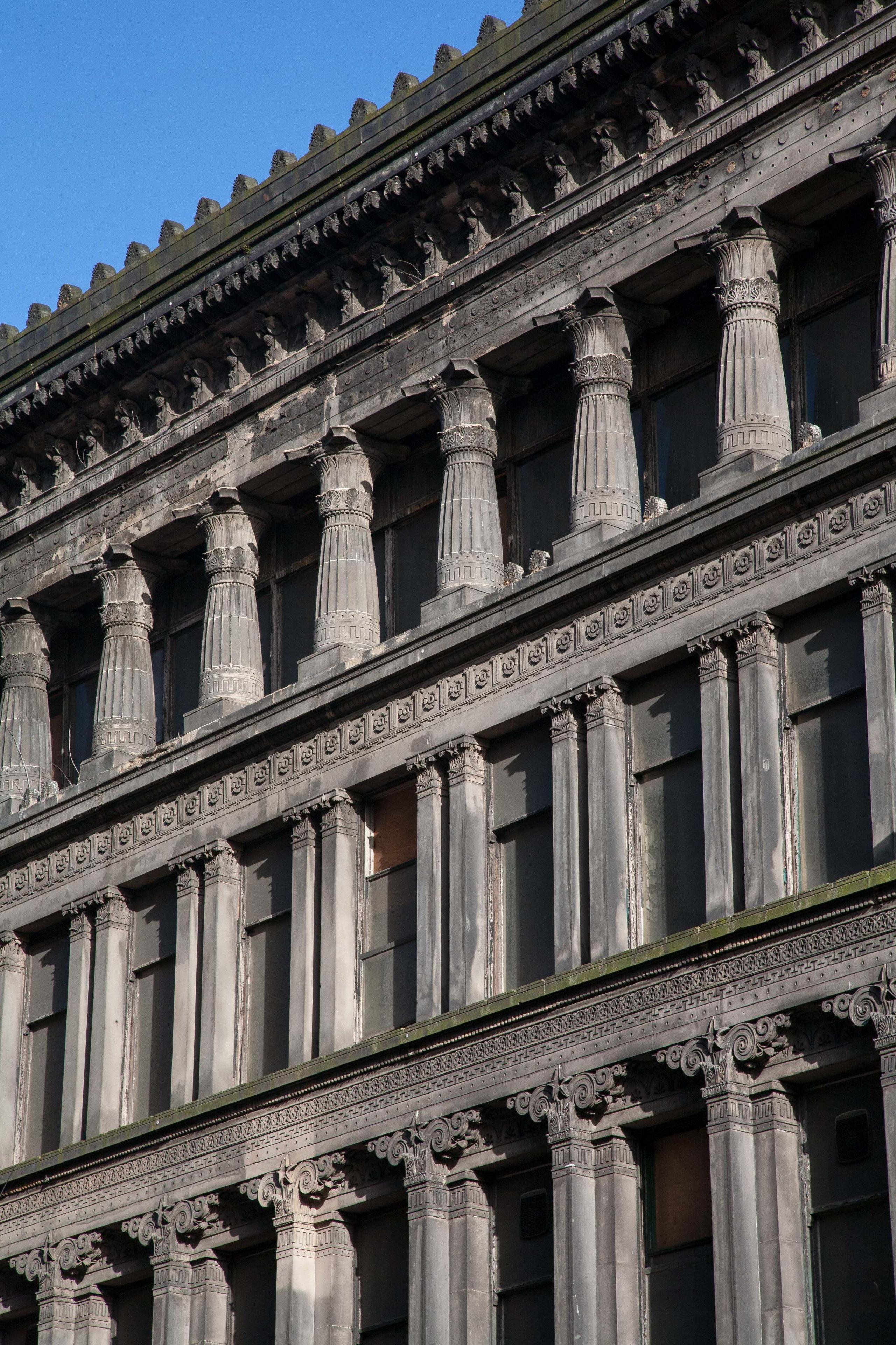 Close up detail of the sandstone façade architecture of the Egyptian Halls building