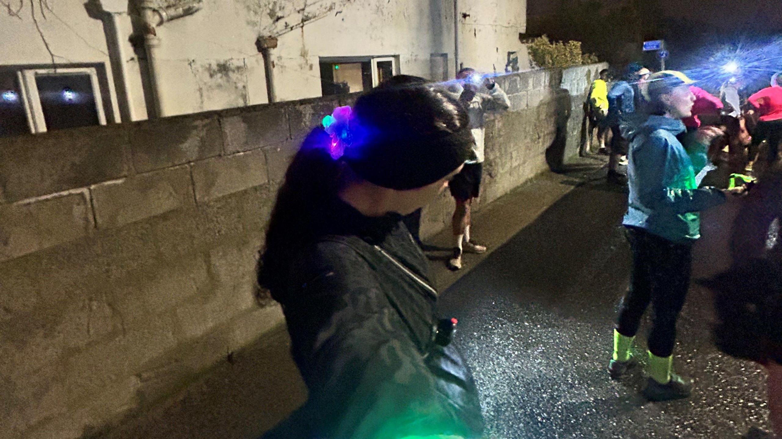 Millie Owen taking a selfie with her glow in the dark hairband and hi-vis clothing. 