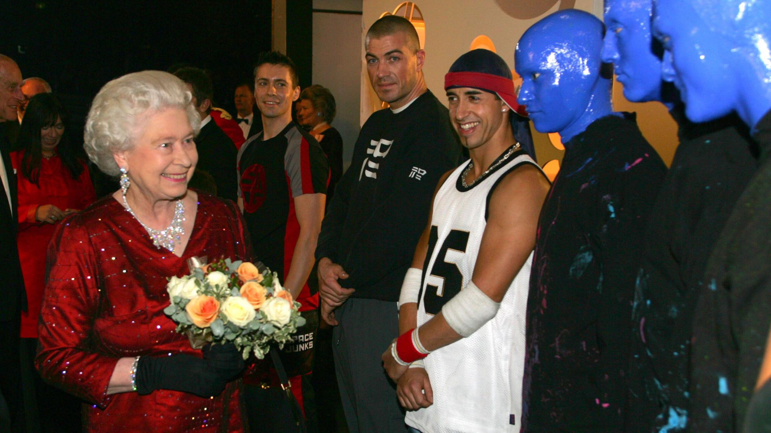 Queen Elizabeth II meets the Blue Man Group at the Wales Millennium Centre for the 77th Royal Variety Show in 2005.