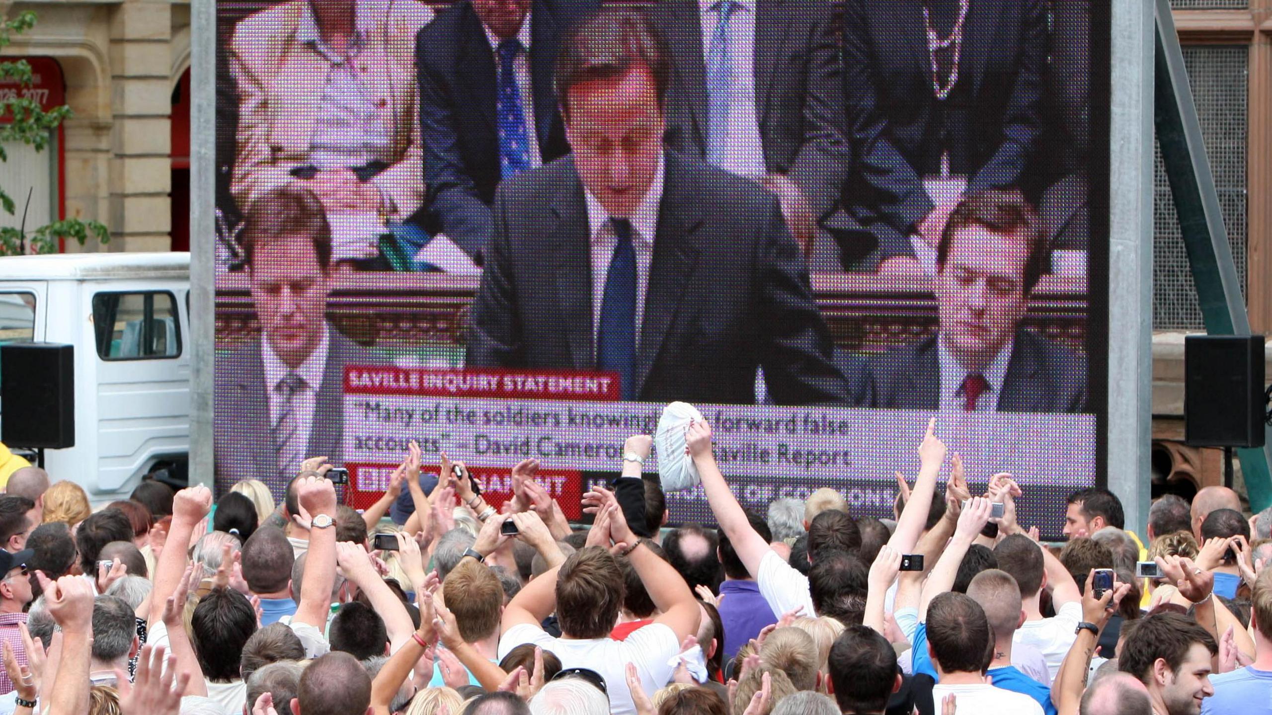 Hundreds of people are packed into Guildhall Square - they are cheering and clapping, watching the then British Prime Minister David Cameron speaking in the House of Commons on a big screen.