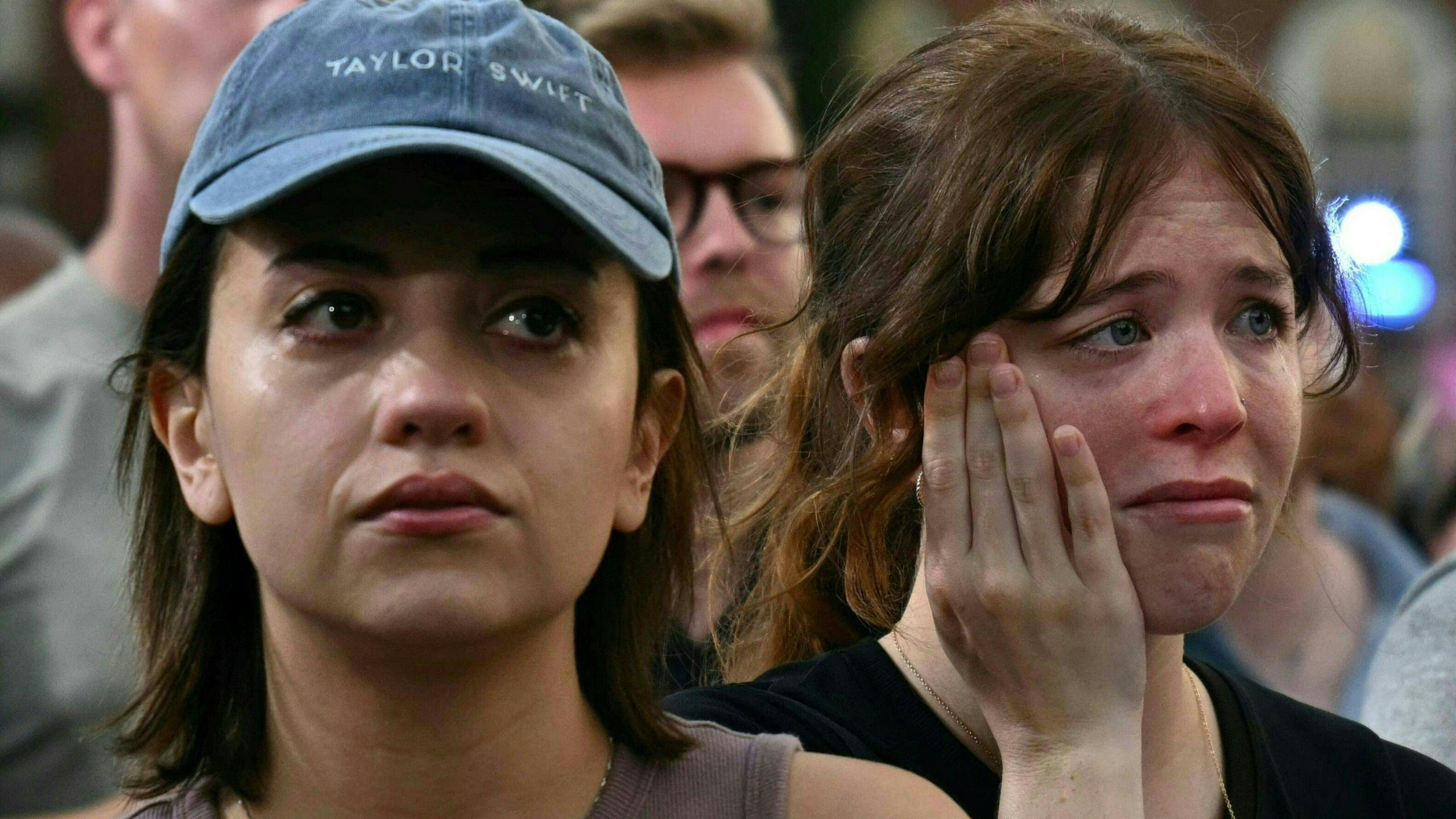 Young women wipe away tears