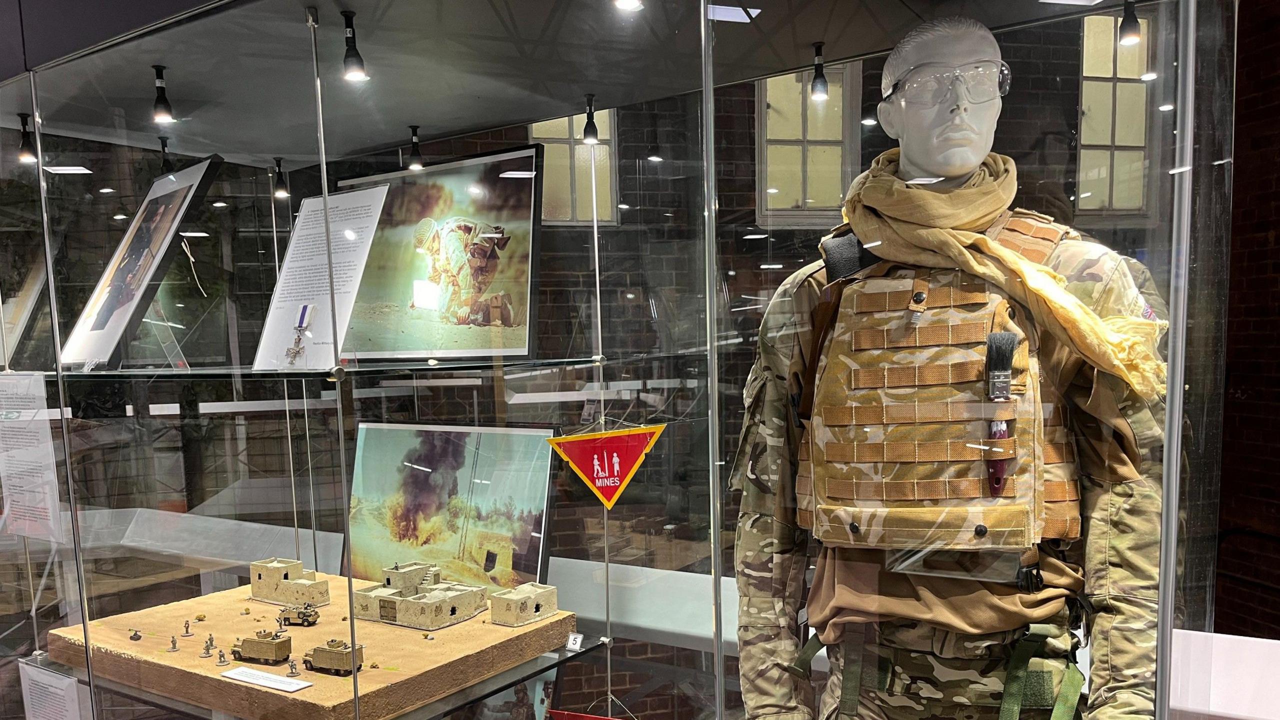 Exhibits at the Royal Engineers Museum in Gillingham, Kent, showing a mannequin in combat kit and a model of a battlefield.