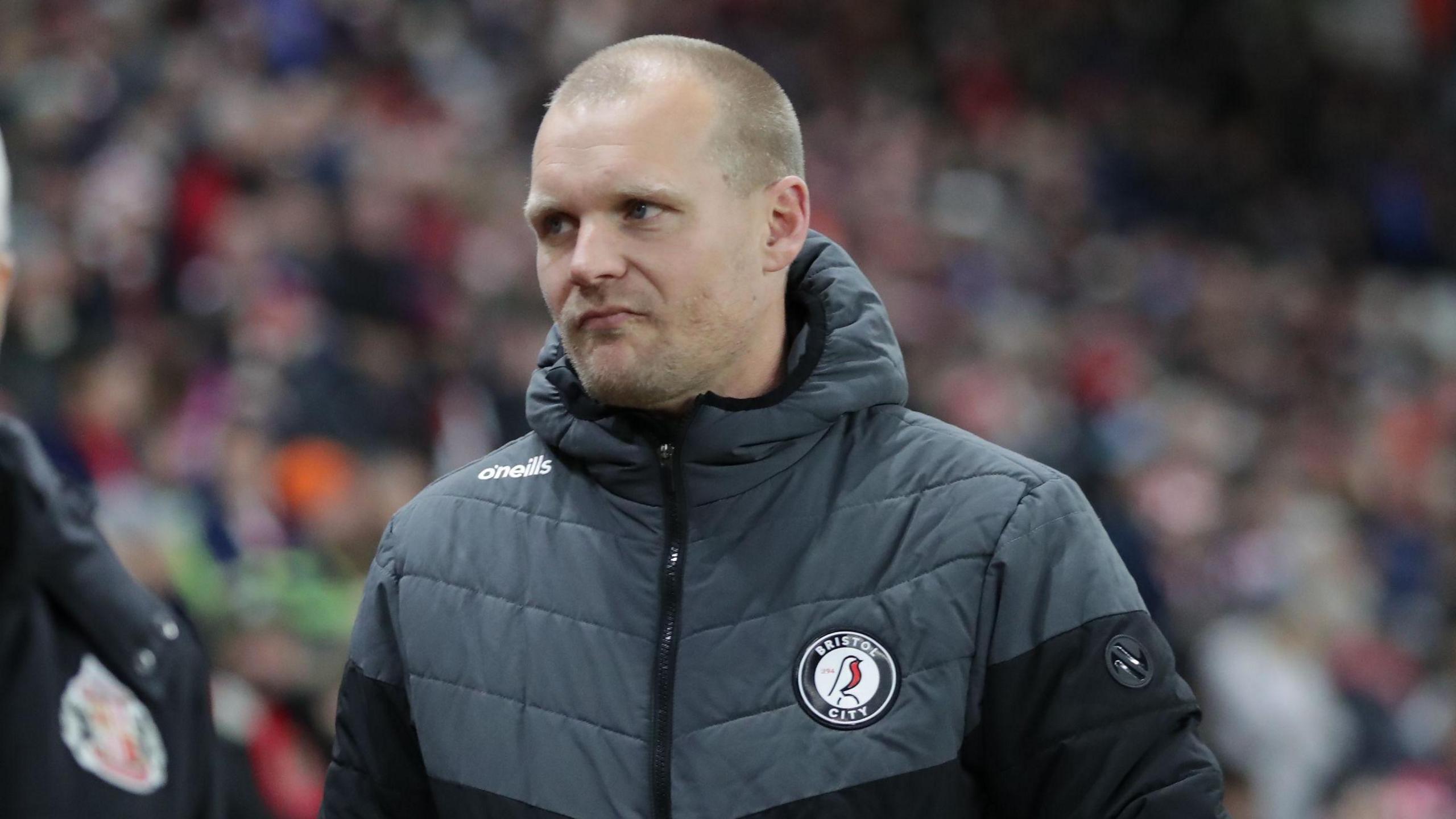 Liam Manning walks on the touchline during the game against Sunderland