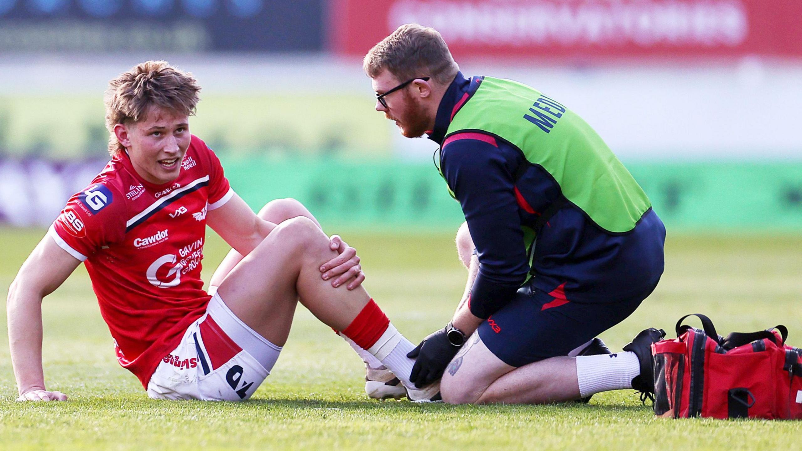 Scarlets wing Ellis Mee, who played in Wales' Six Nations victory against Italy, gets treatment for an ankle injury