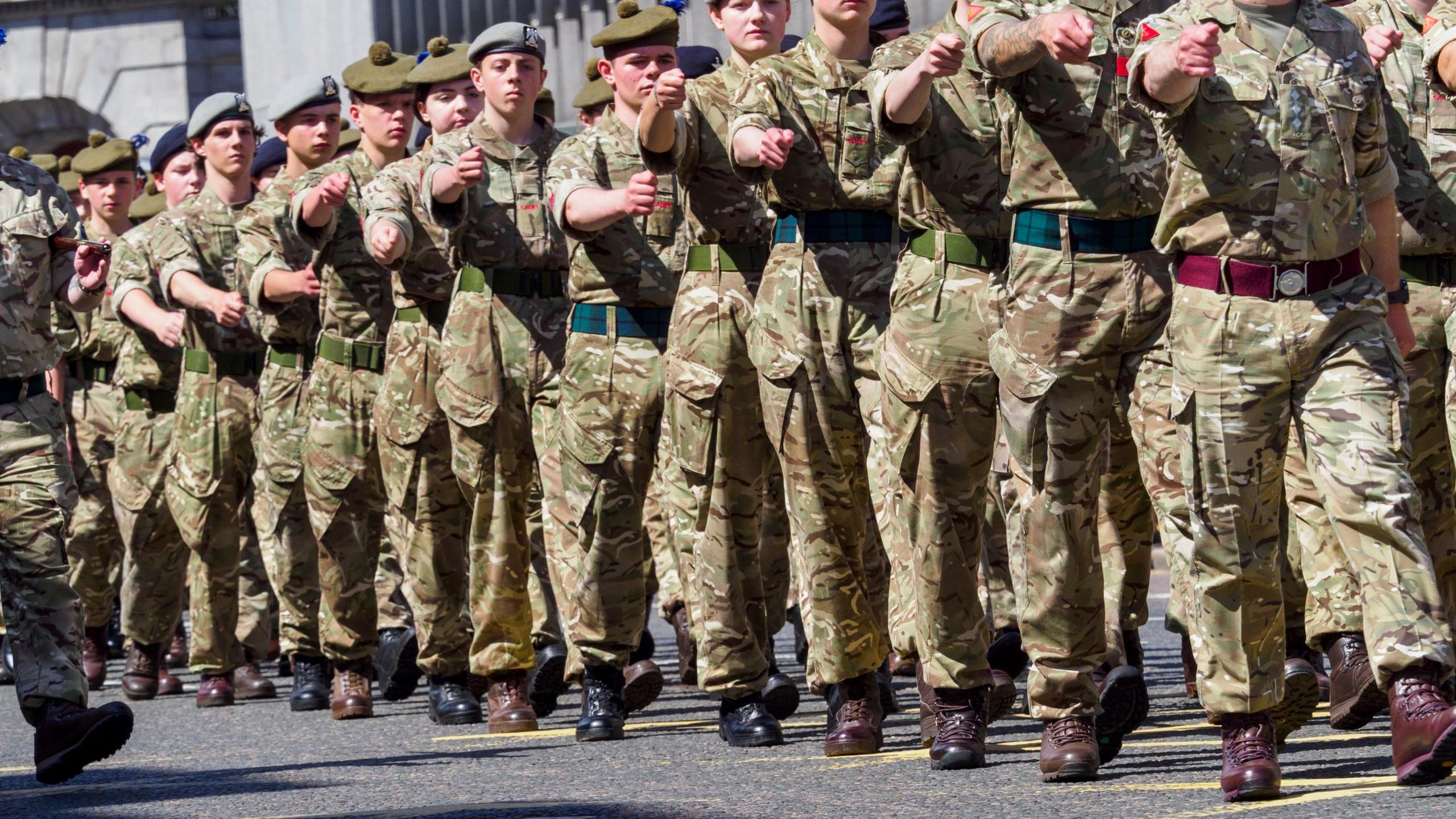 Soldier marching in formation along a street