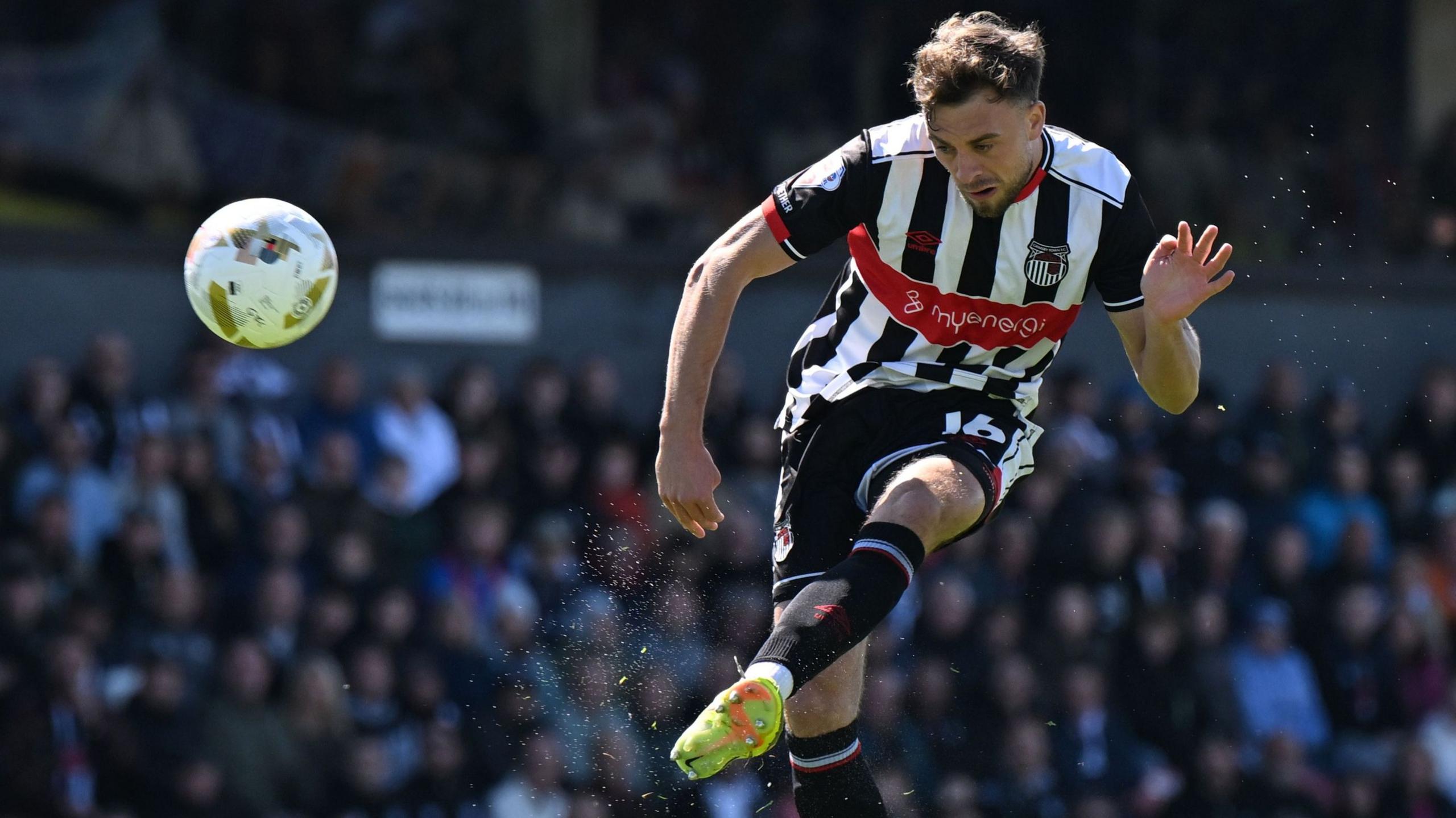 Reece Staunton, of Grimsby Town, scores with a volley