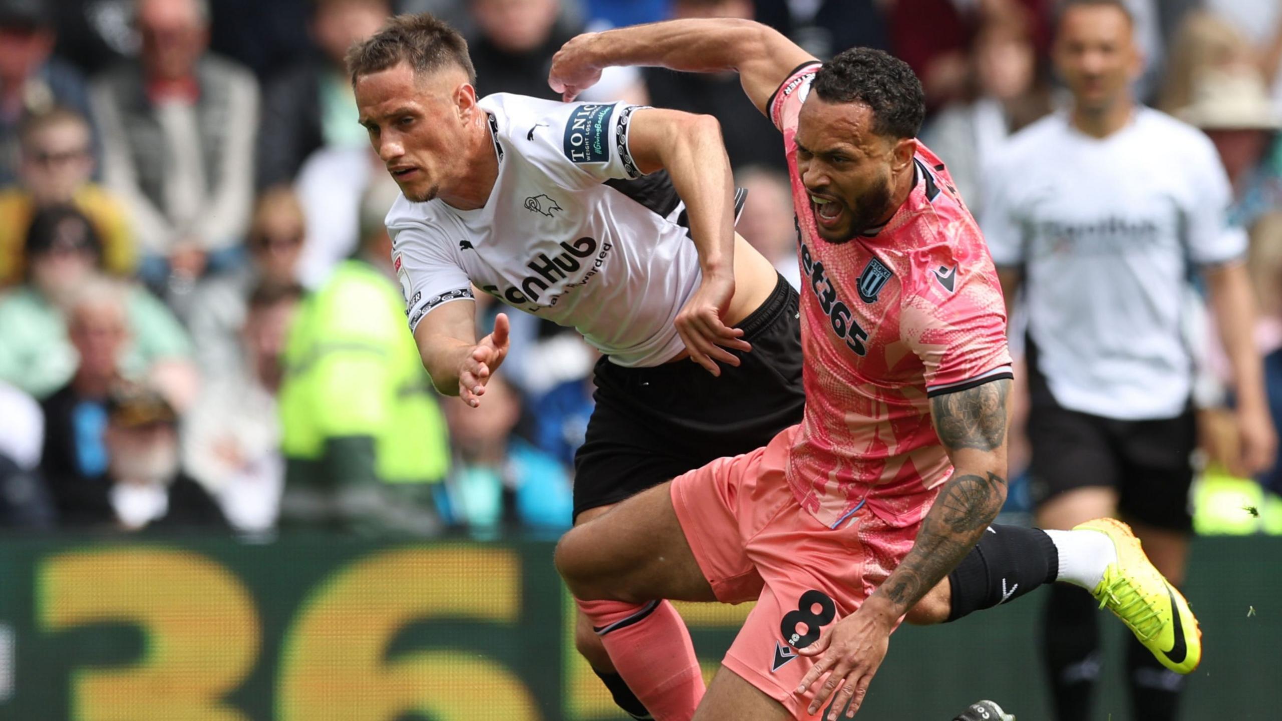Derby County's Jerry Yates (left) and Stoke City’s Lewis Baker battle for the ball