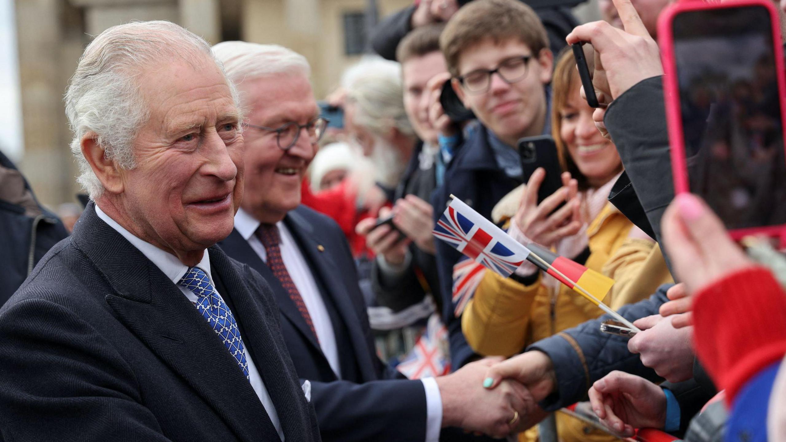 King Charles and President Steinmeier during the state visit to Germany in 2023. King Charles is pictured shaking hands with members of the public.
