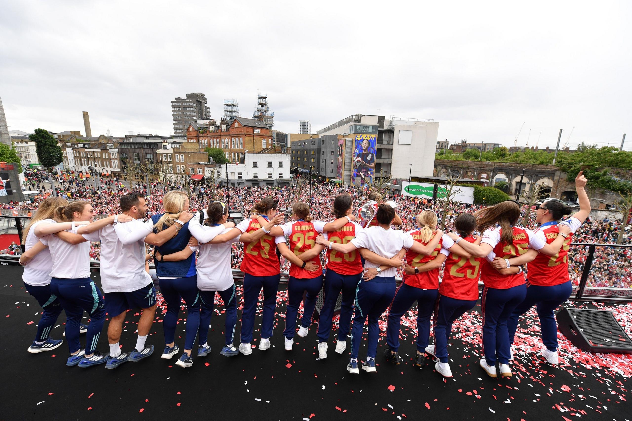 Arsenal players dance in front of fans