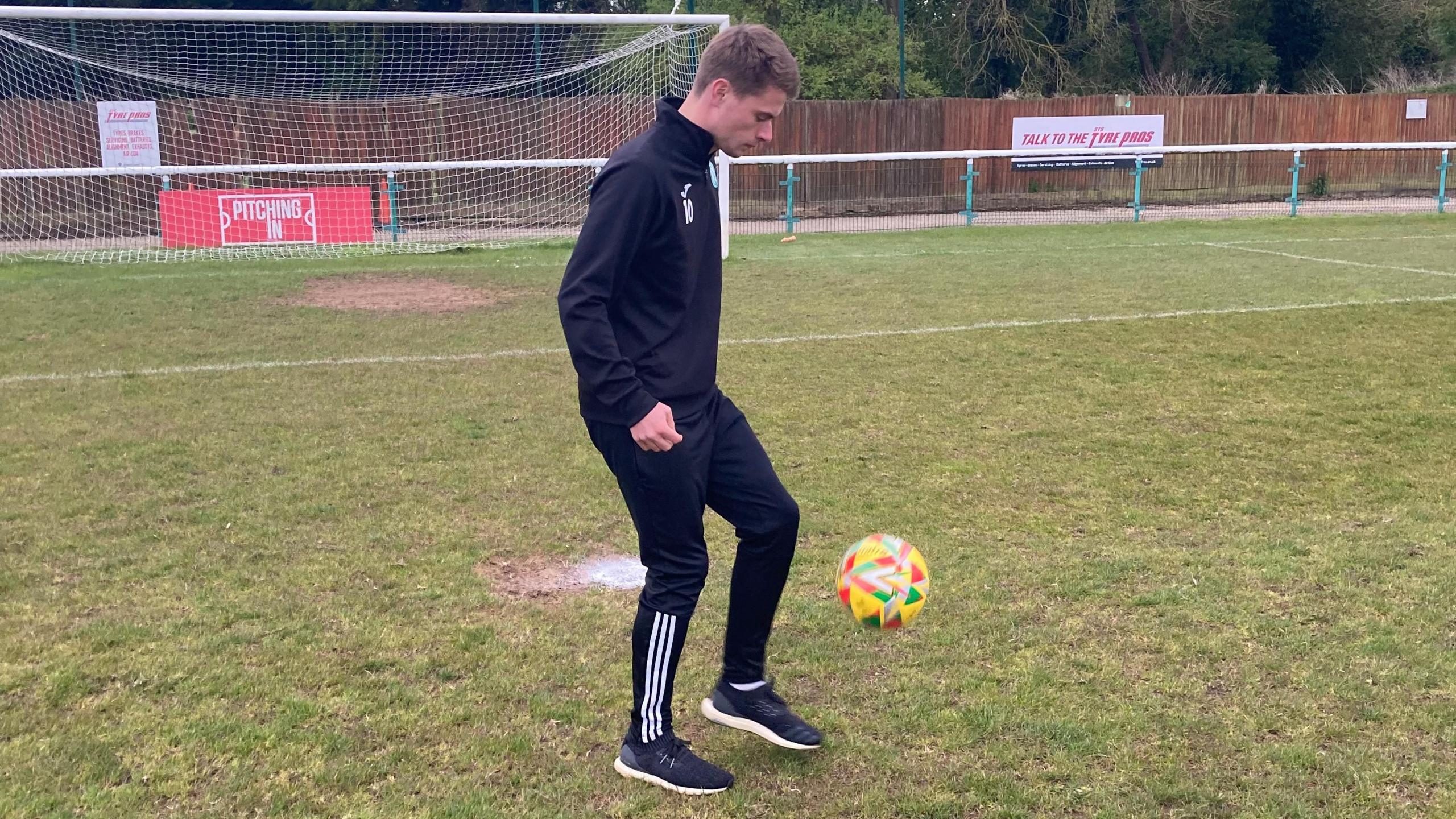 JJ Lacey playing kick ups with a ball on the Bigglewade ground