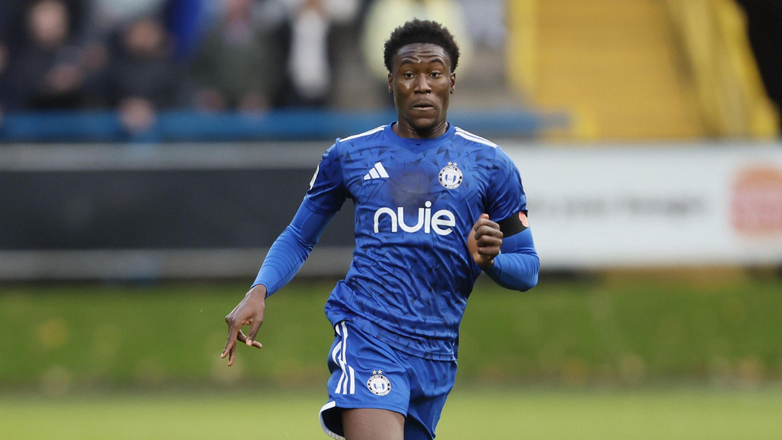 Thierry Latty-Fairweather runs on the pitch during a match for Halifax Town in November 2025