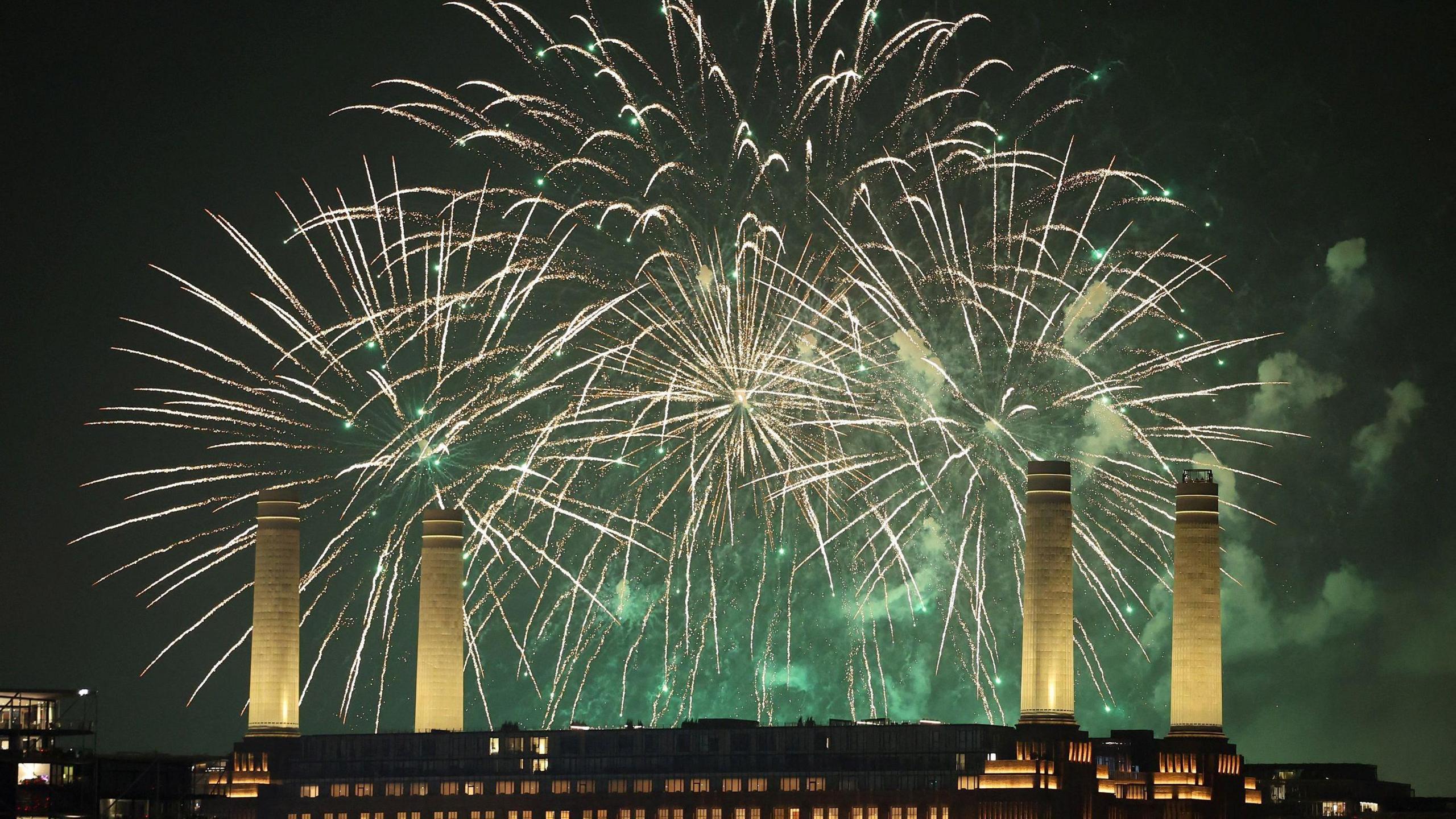 Firework display behind the towers of Battersea Power Station in London