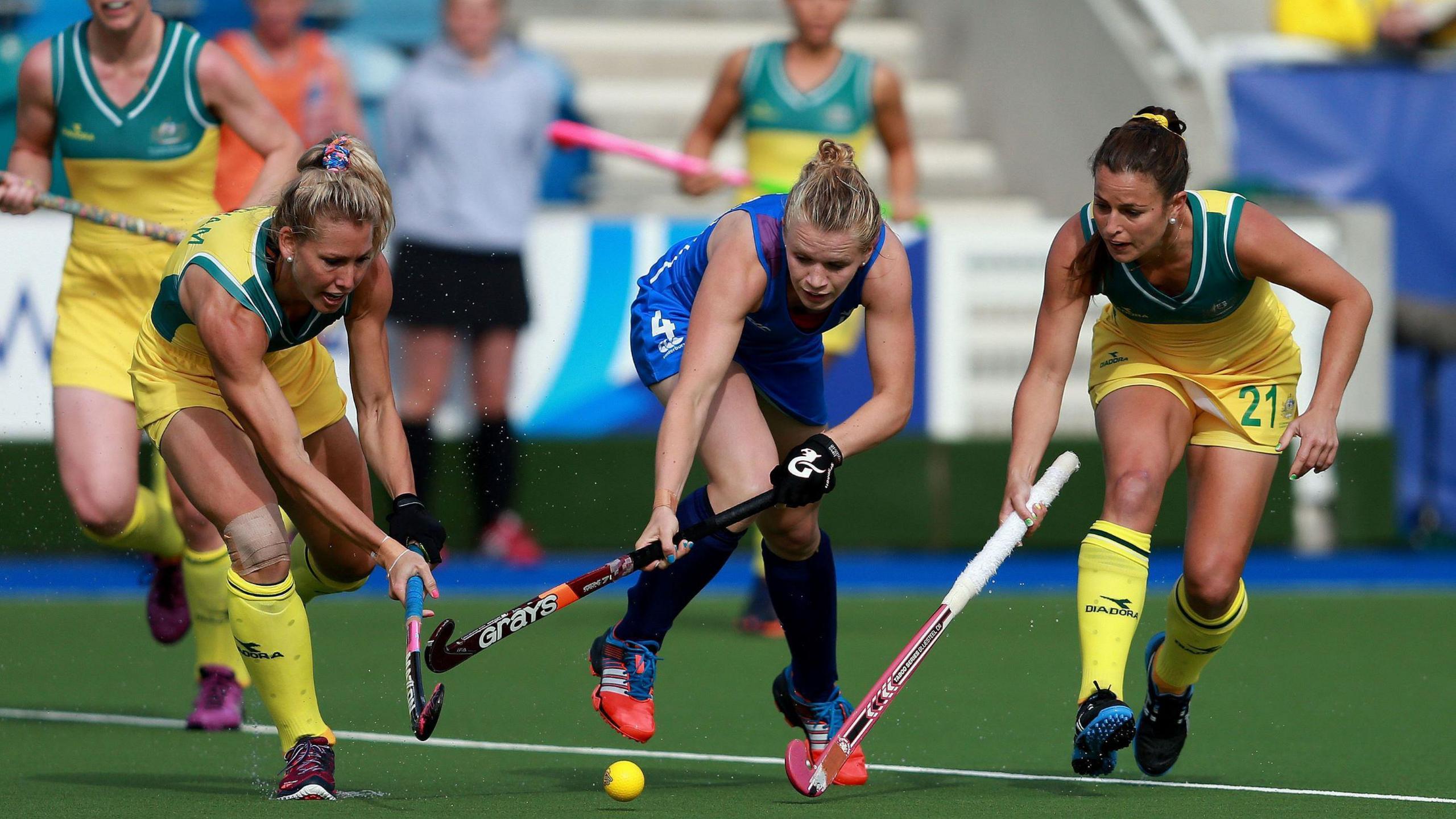 Scotland's Morag McLellan, in blue kit is tackled by Australia's Casey Eastham and Jayde Taylor, in yellow and green kit, during the Womens Pool Hockey match at the National Hockey Centre, during the 2014 Commonwealth Games in Glasgow.