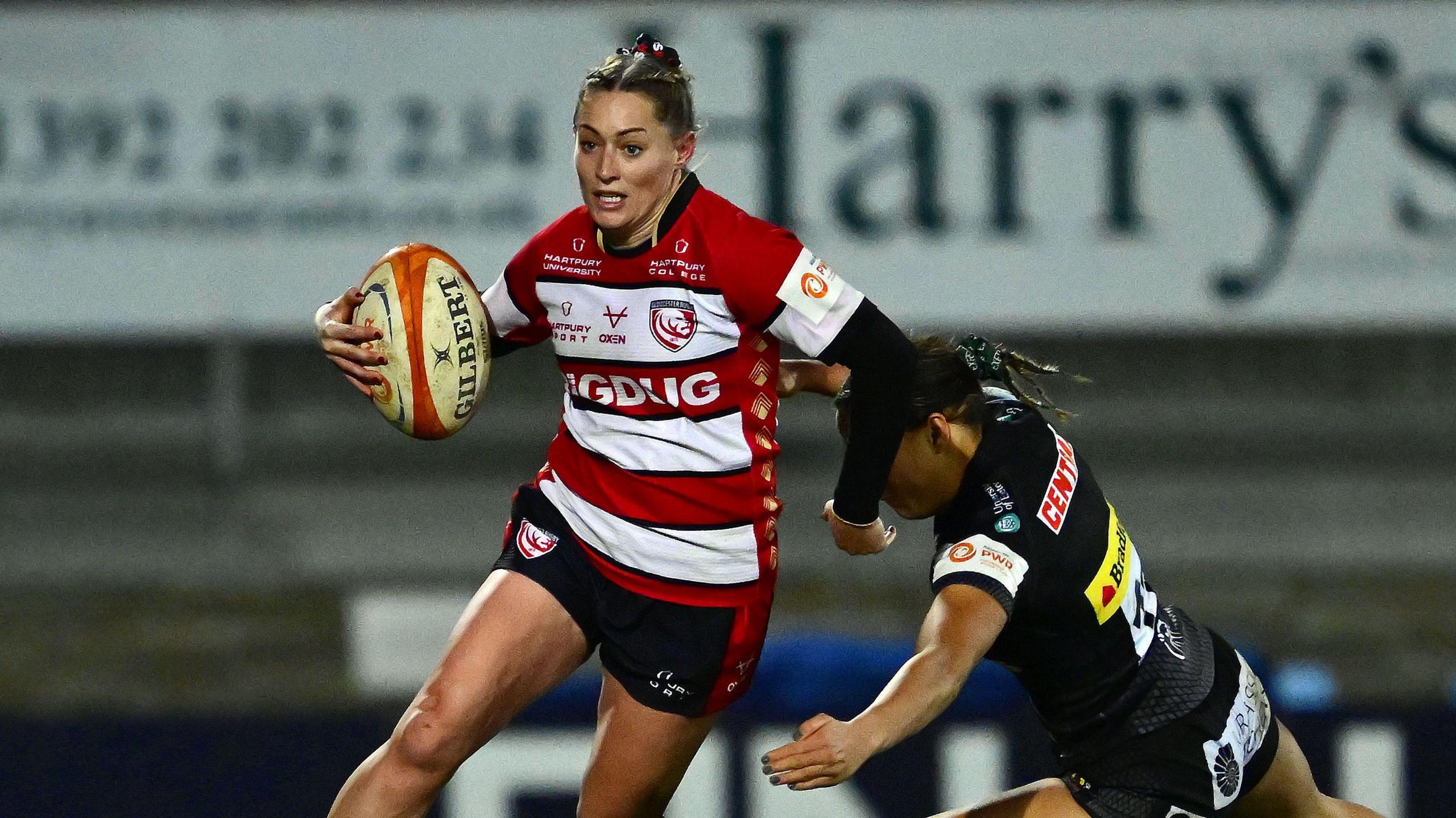 Natasha Hunt runs with the ball during a match