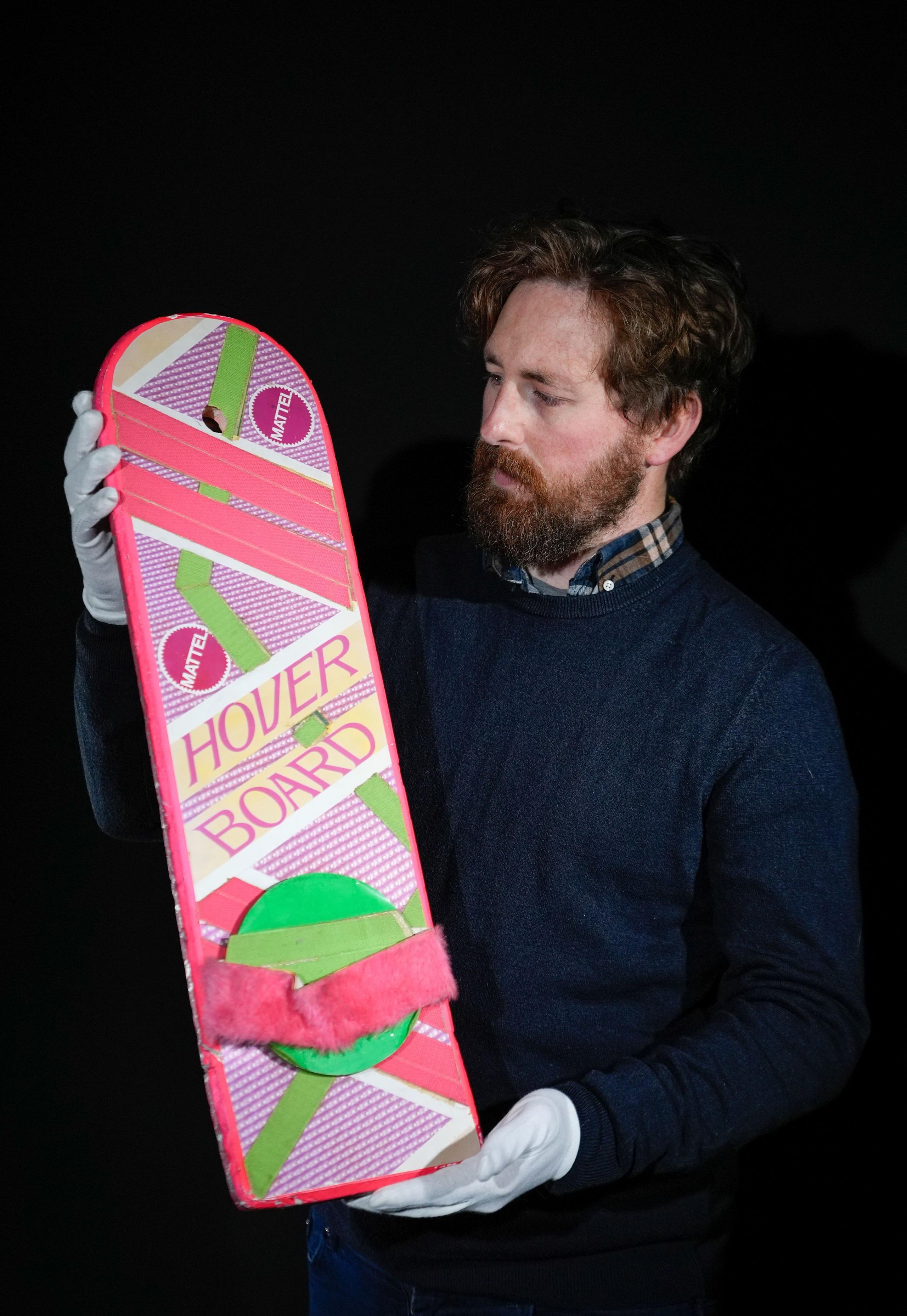 A Propstore employee looks at Marty McFly's (Michael J. Fox) Hoverboard from the 1989 and 1990 films “Back to the Future Part II' and 'Back to the Future Part III' (estimate £60,000 - 120,000).