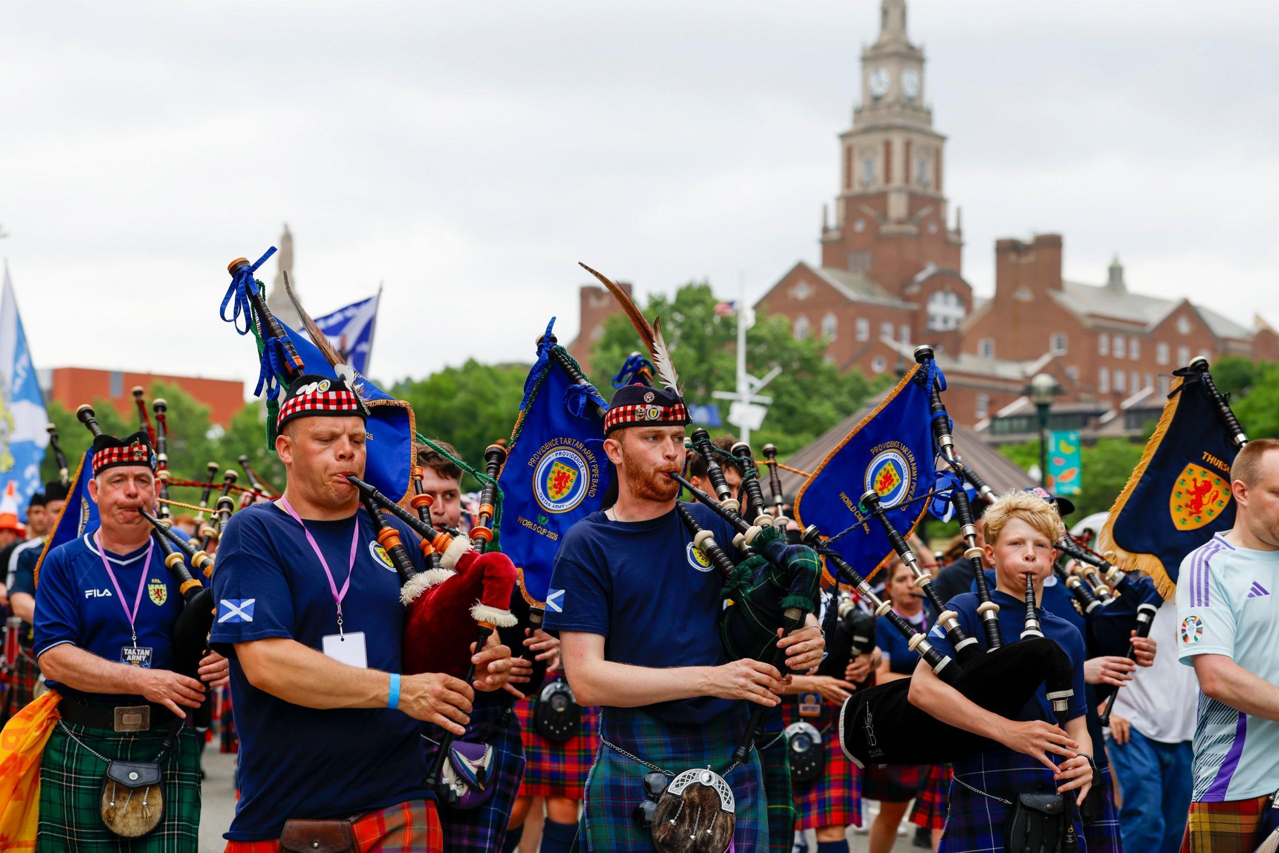 Pipers in traditional outfits in Boston