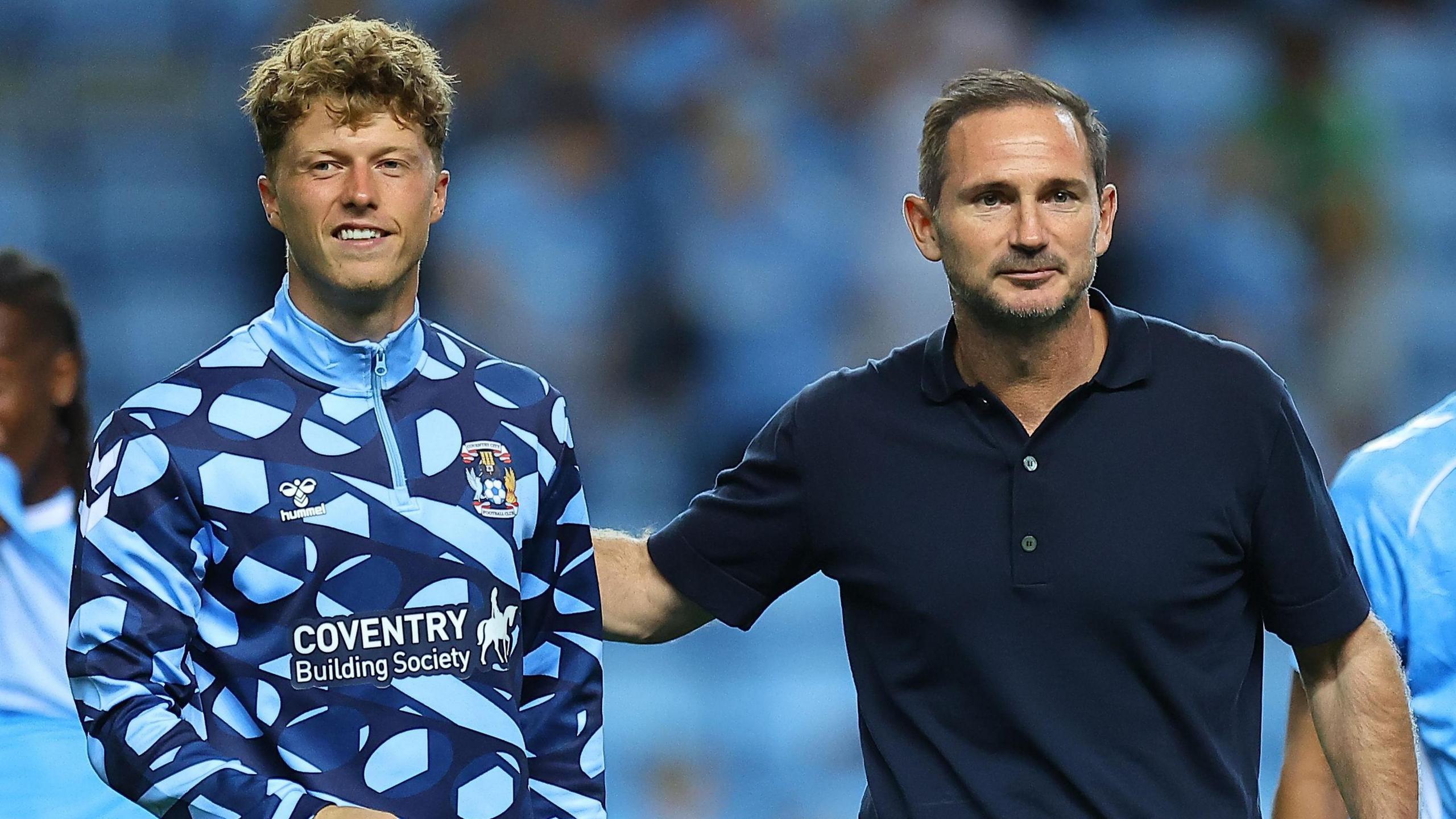 Victor Torp walks off after a game alongside Coventry City head coach Frank Lampard