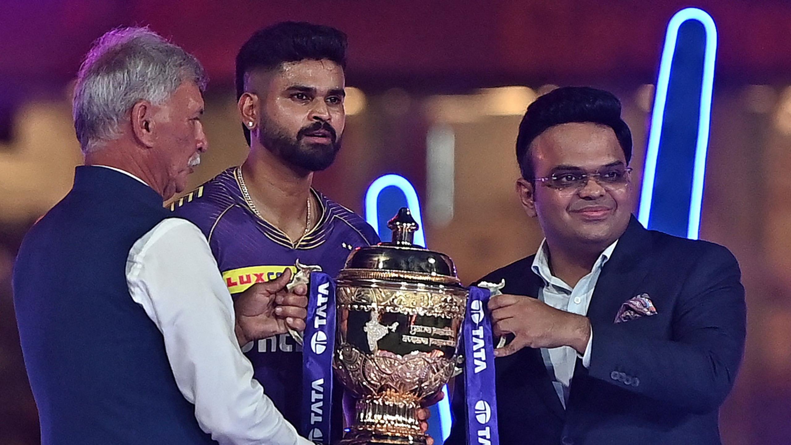 Roger Binny (L), president of the Board of Control for Cricket in India (BCCI) along with Jay Shah (R), secretary of the BCCI, presents the winning trophy to Kolkata Knight Riders' captain Shreyas Iyer at the end of the Indian Premier League (IPL) Twenty20 final cricket match between Sunrisers Hyderabad and Kolkata Knight Riders at the MA Chidambaram Stadium in Chennai on May 26, 2024